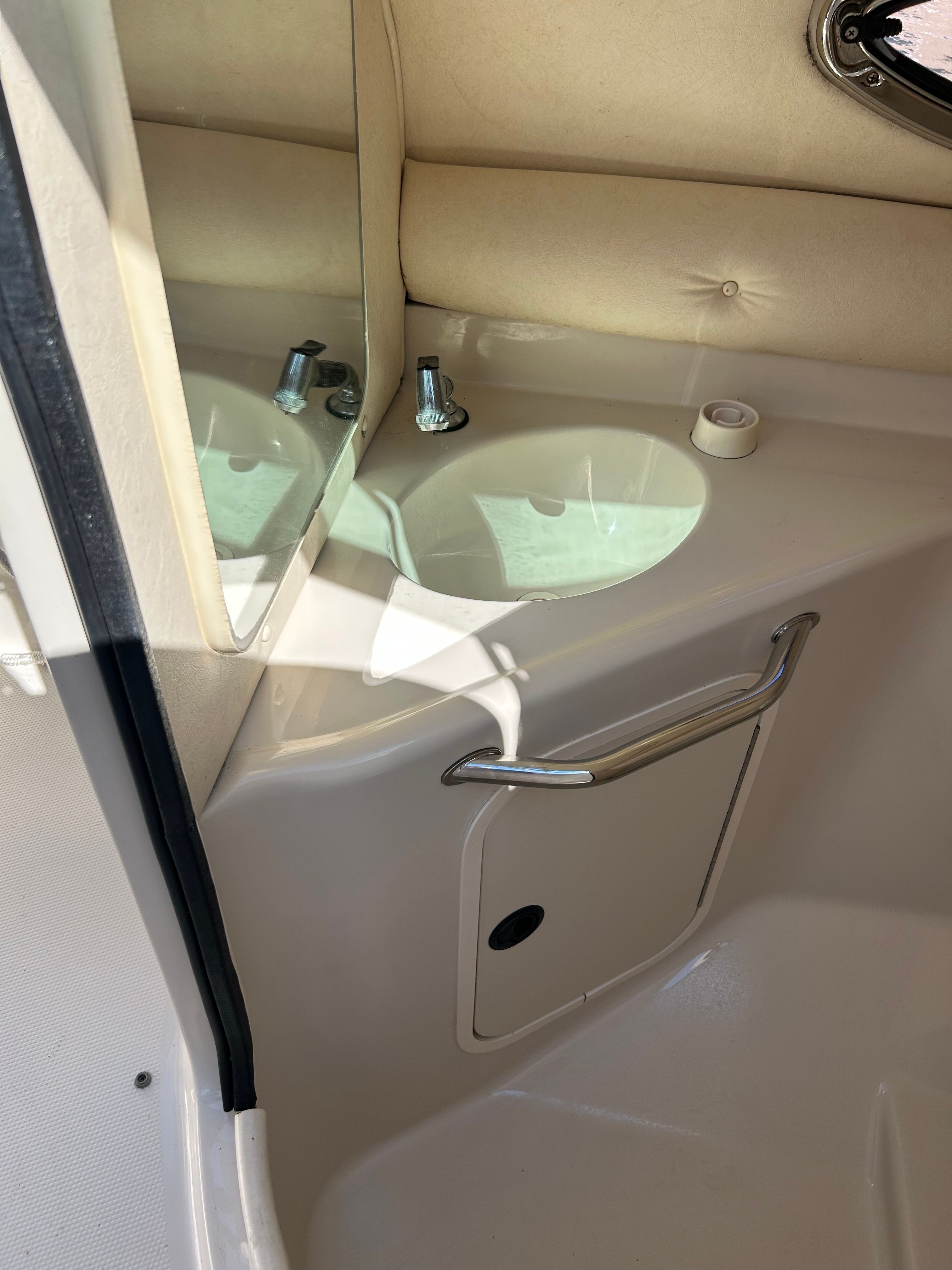 Interior of a 2003 Sea Ray 240 Sundeck boat with sink.