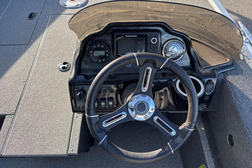 2024 Starweld 16 Fusion SC Pro boat dashboard with steering wheel and controls.