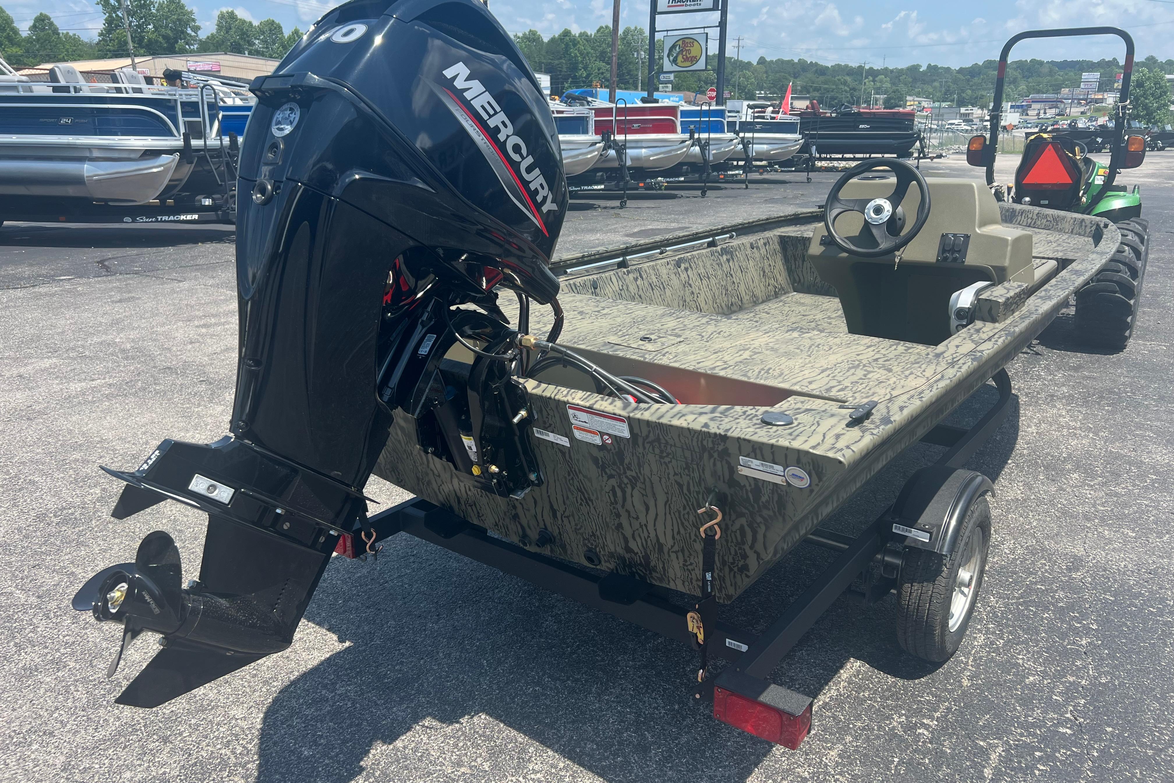 2026 Tracker Grizzly 1648 SC boat with Mercury outboard motor on trailer.