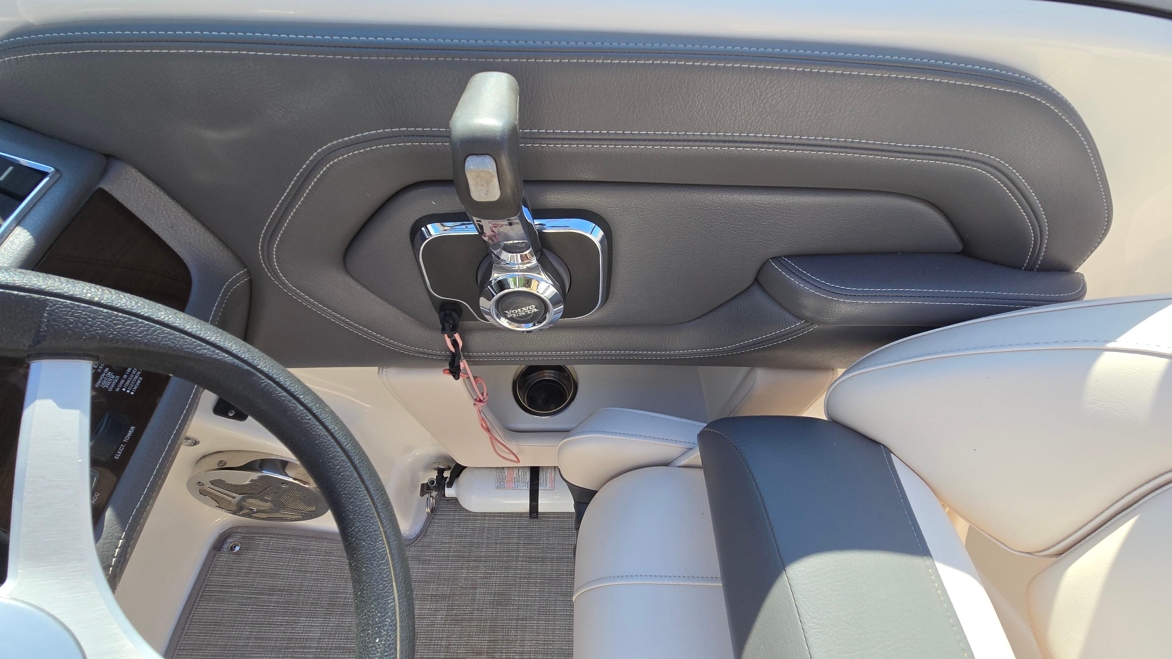 2018 Chaparral 224 Sunesta boat interior, featuring steering wheel and throttle controls.