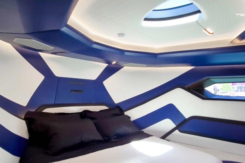 Luxurious Tecnomar LY63 2026 yacht interior with modern blue and white design, featuring a cozy bed.