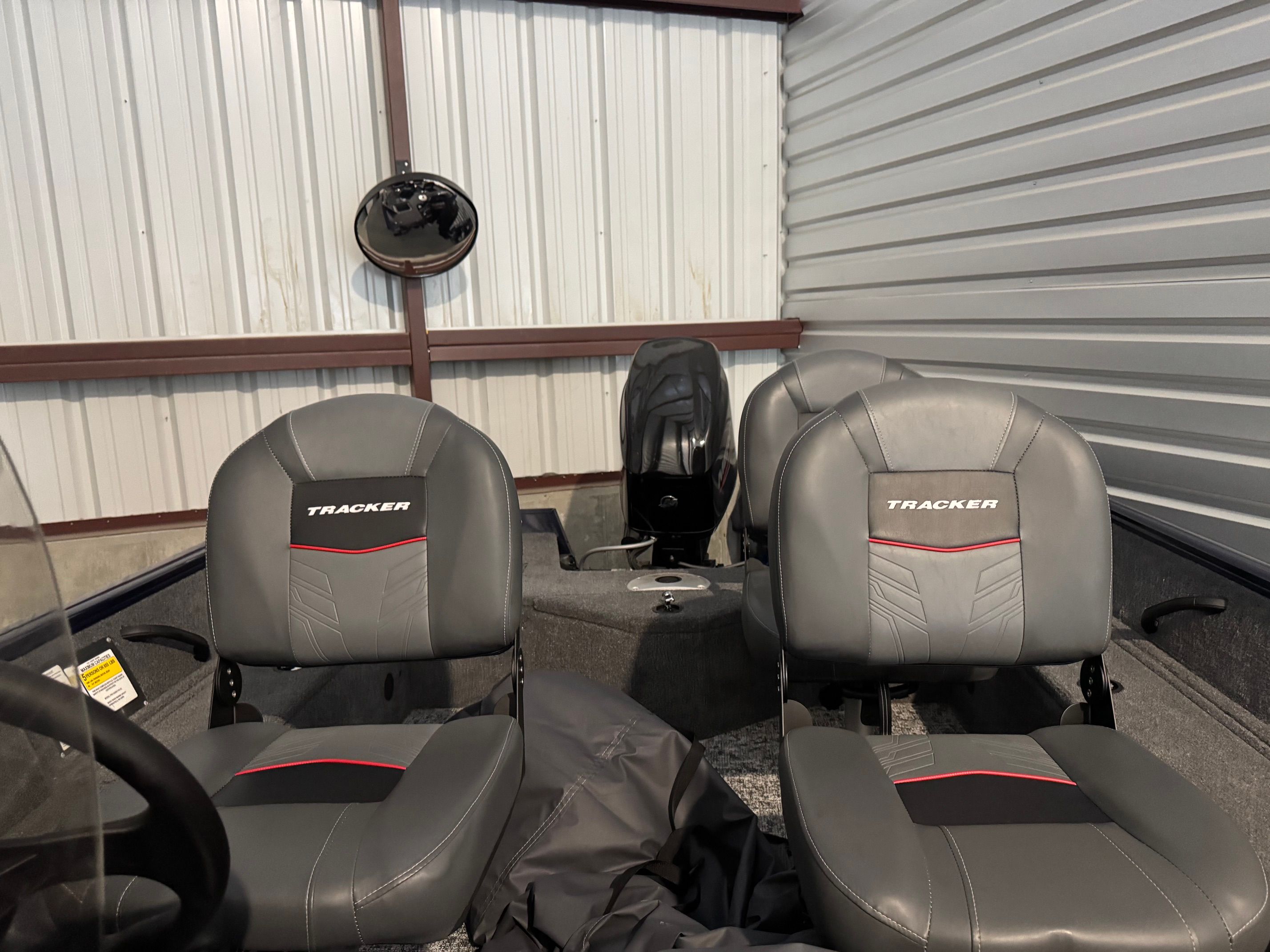 Interior view of a Tracker Pro Guide V-16 SC with gray seats and an engine.