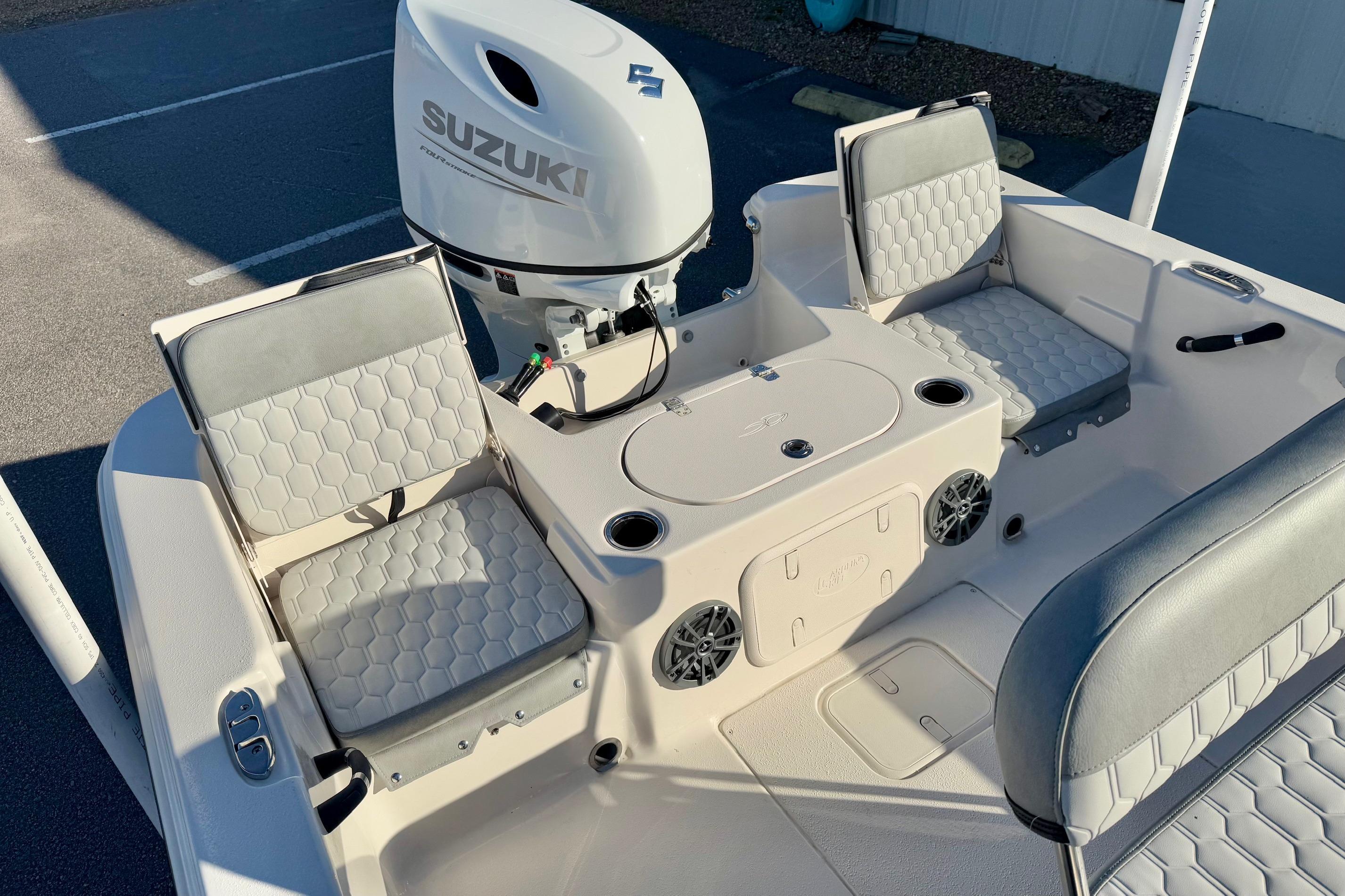 2025 Carolina Skiff 21 LS boat interior with Suzuki engine and cushioned seating.
