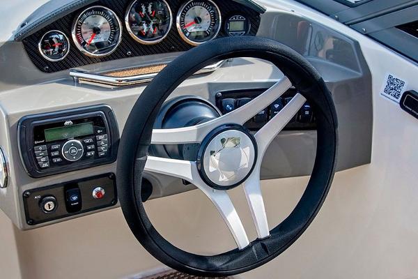 Manufacturer Provided Image: 2018 Stingray 214 LR boat dashboard with steering wheel and control panel.