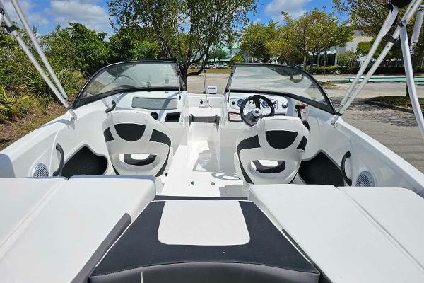 2025 Tahoe 185 S boat interior with dual seats and dashboard, parked outdoors.