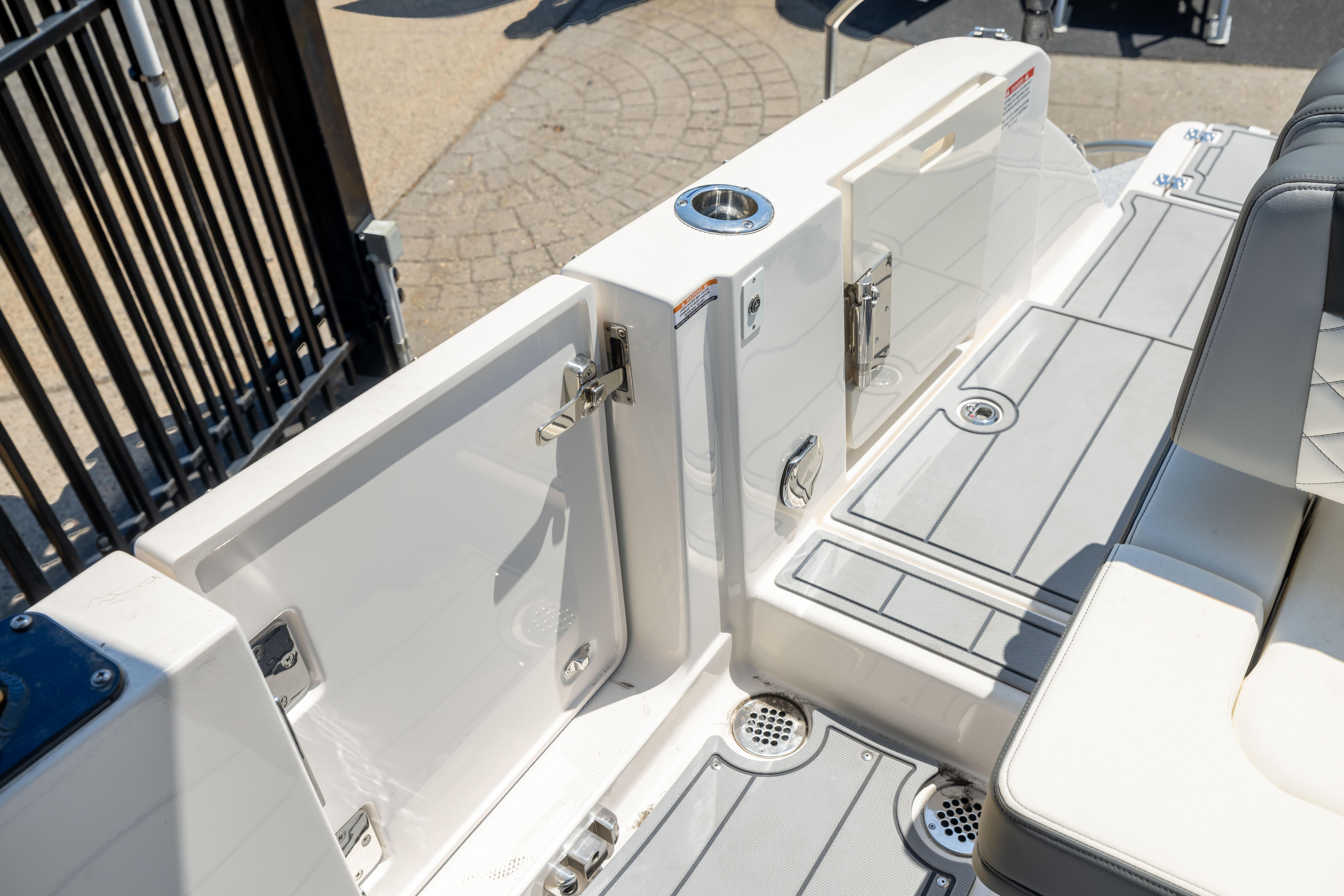 2026 Chaparral 310 OSX boat deck with seating and storage compartments.