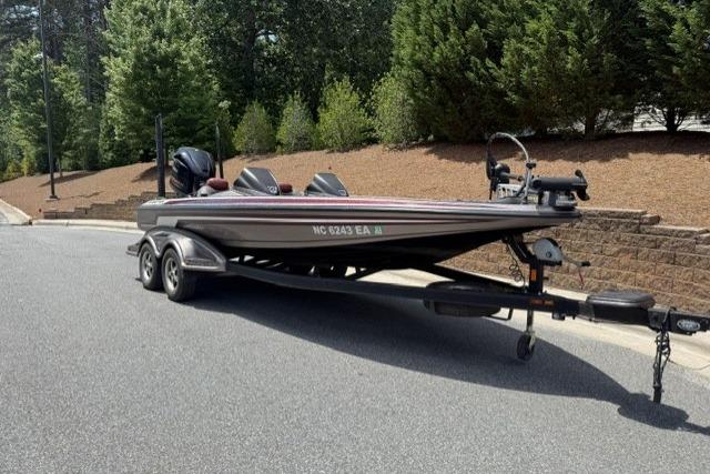 2013 Skeeter FX21 bass boat on trailer, parked on a suburban street.