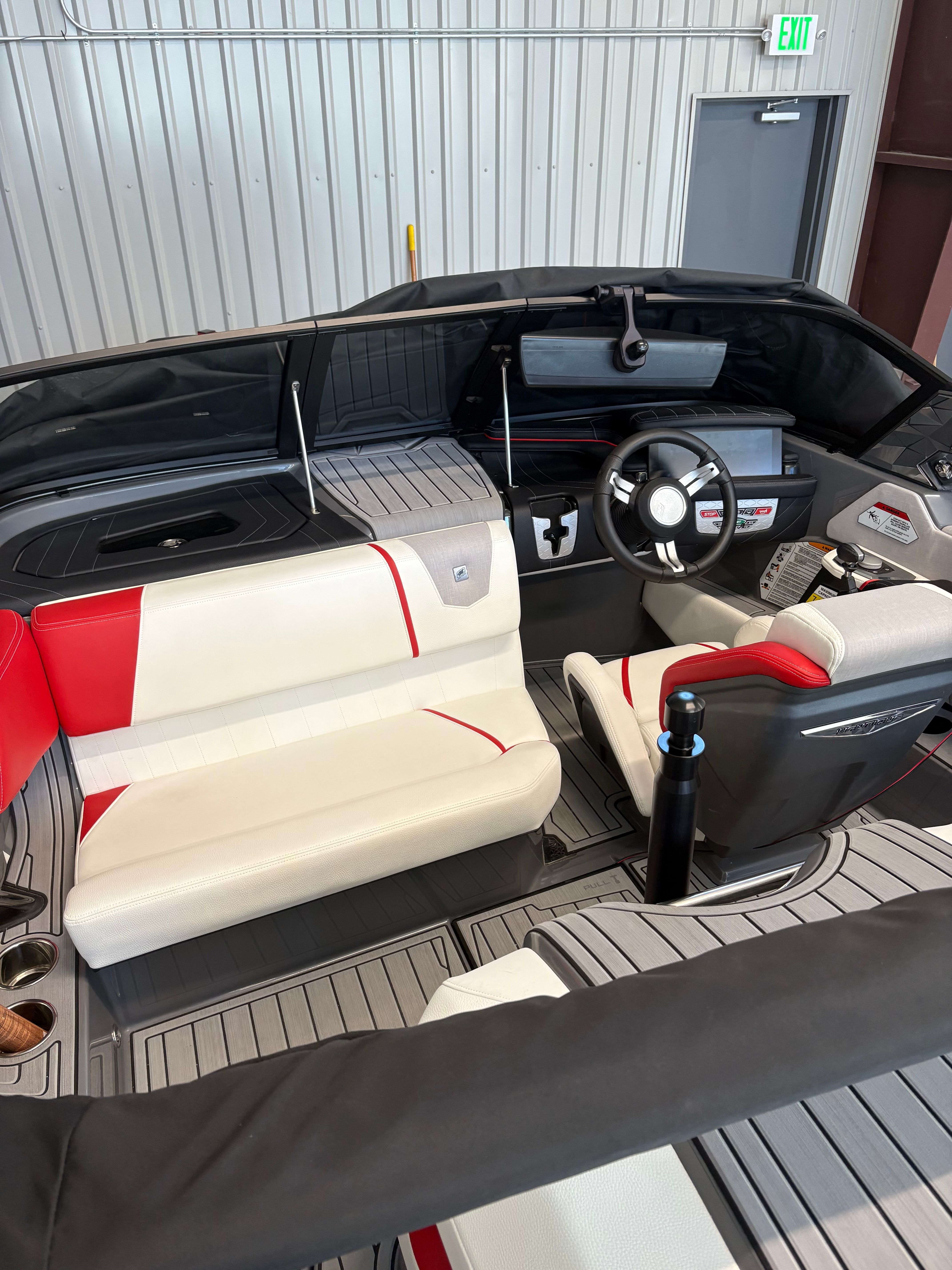 The interior of a 2023 Nautique Ski Nautique with modern seating and a sleek dashboard.