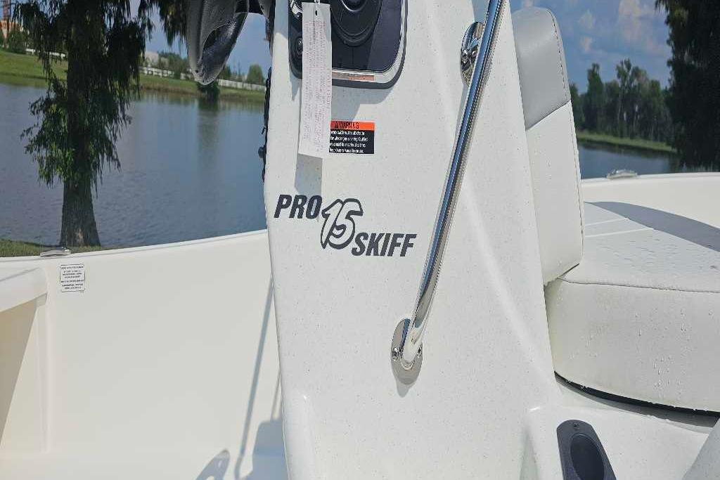 2026 Mako Pro Skiff 15 CC boat console by a serene lake.