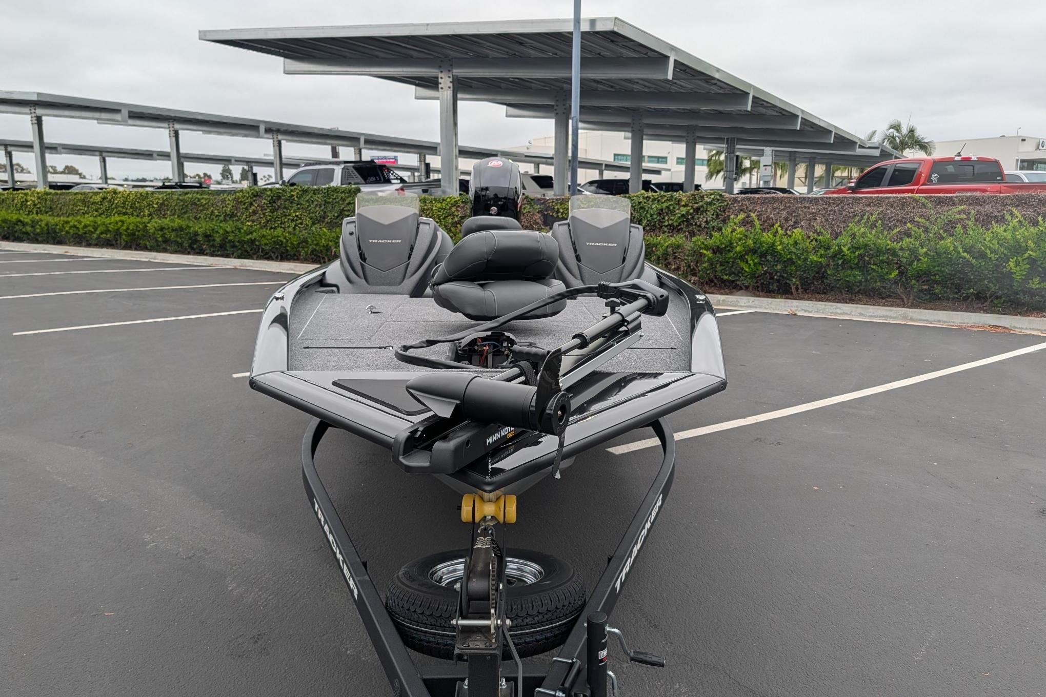 2026 Tracker Pro Team 195 boat parked in a lot, featuring sleek design and modern equipment.