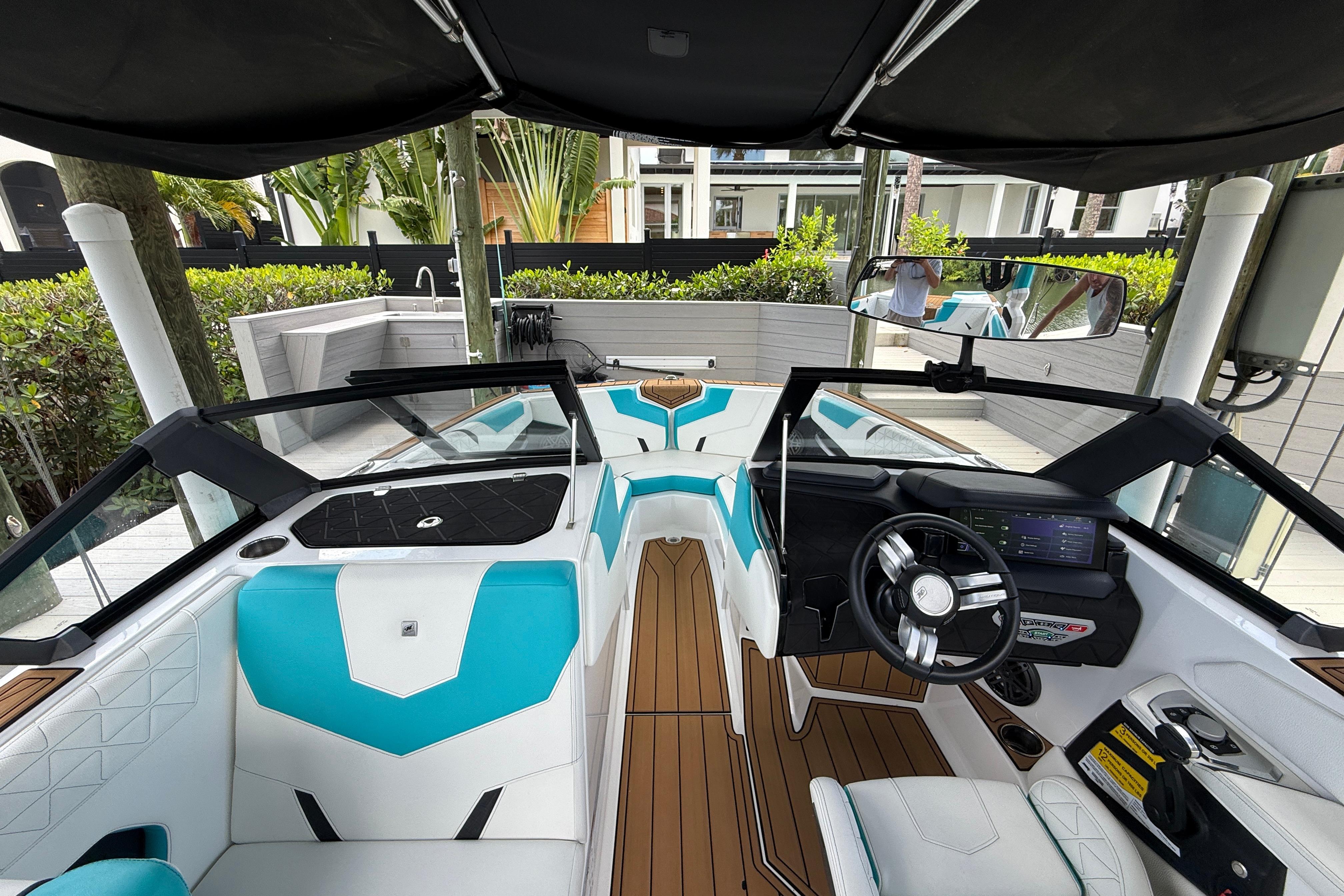 2024 Nautique Super Air Nautique GS20 interior with modern dashboard and turquoise seating.