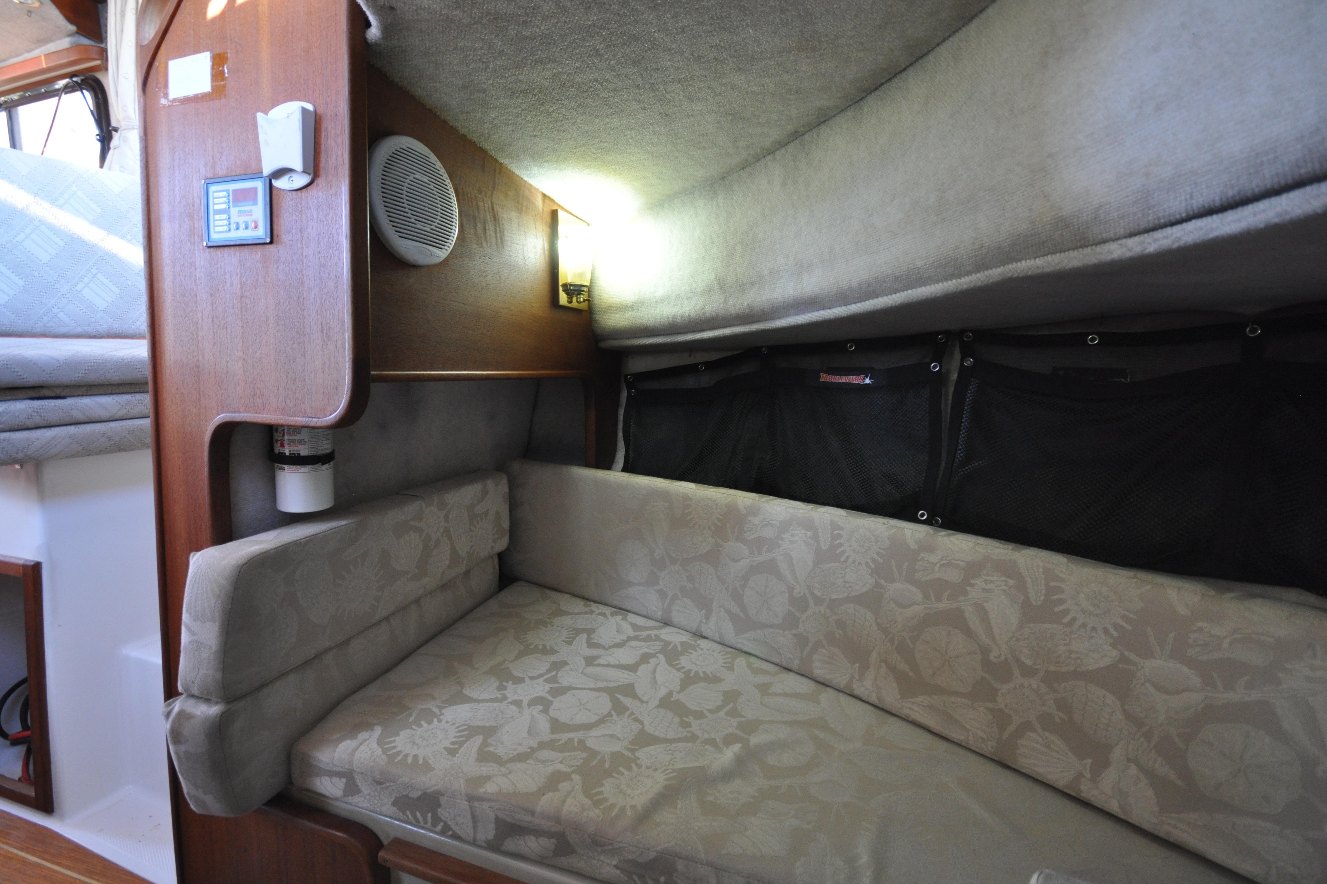 2007 Ranger Tug R-25 interior cabin with cushioned seating and wooden paneling.