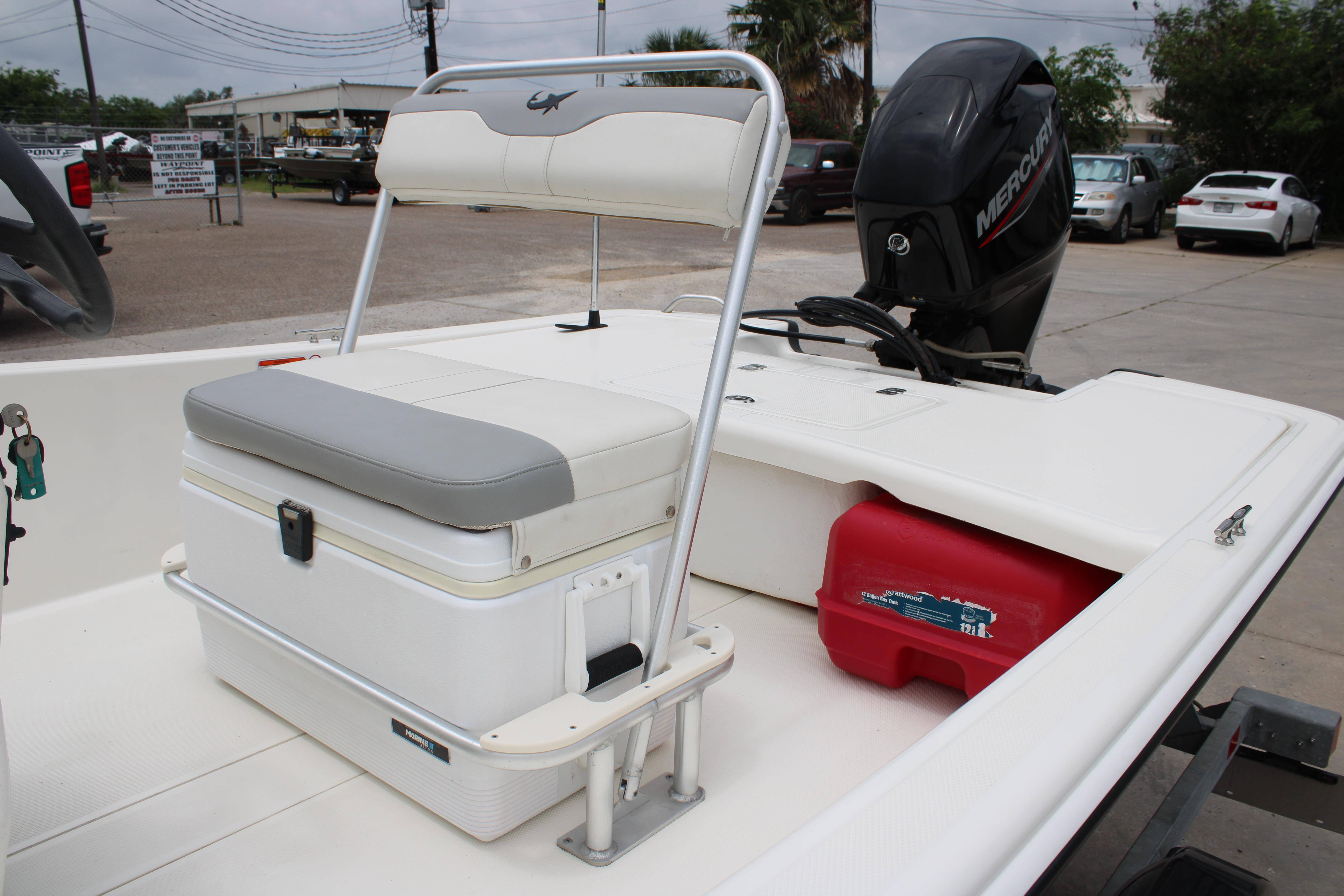 2021 Mako Pro Skiff 17 CC boat interior with seating and Mercury outboard motor.