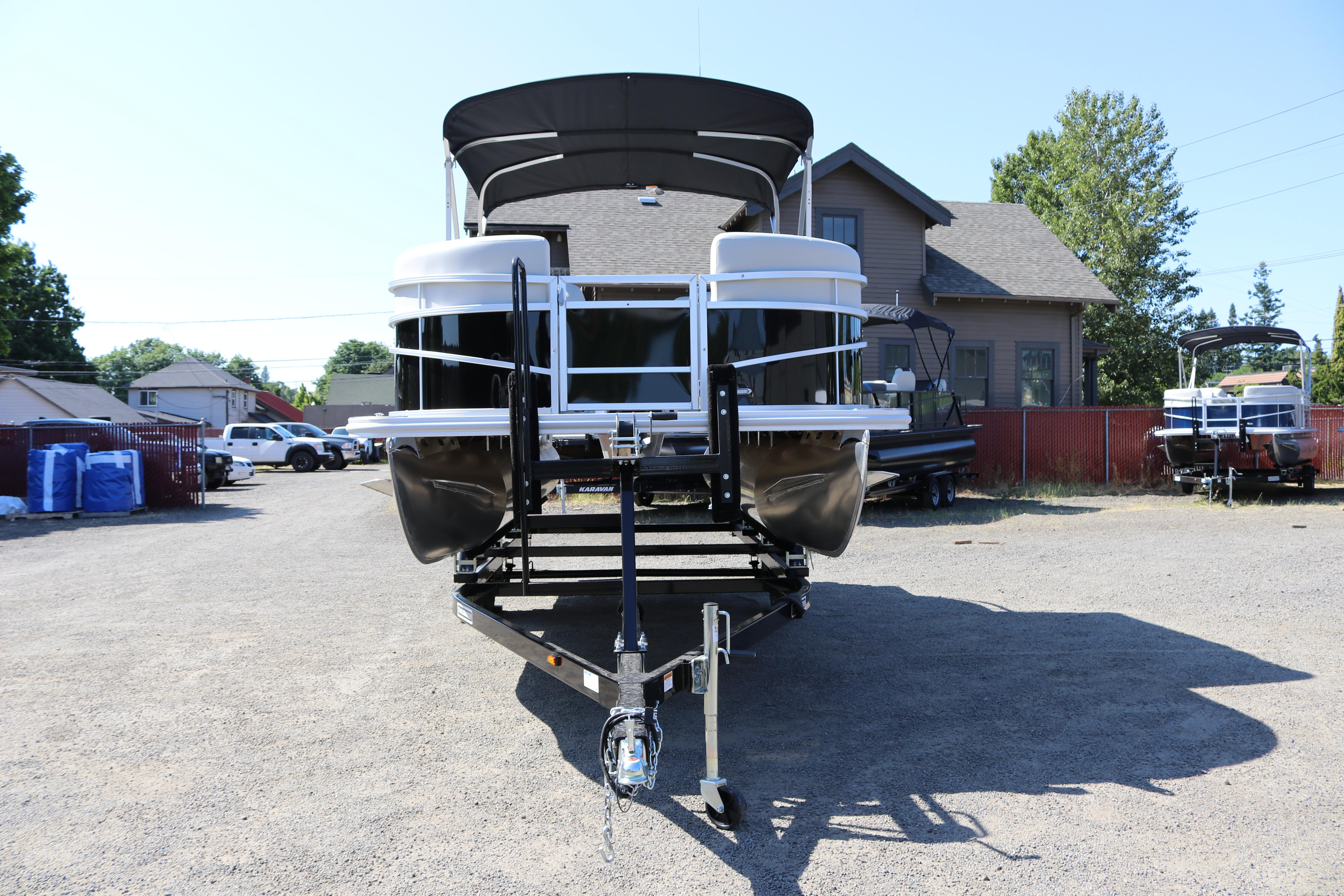 2025 SunChaser Vista 20 Fish pontoon boat on trailer, parked outdoors.
