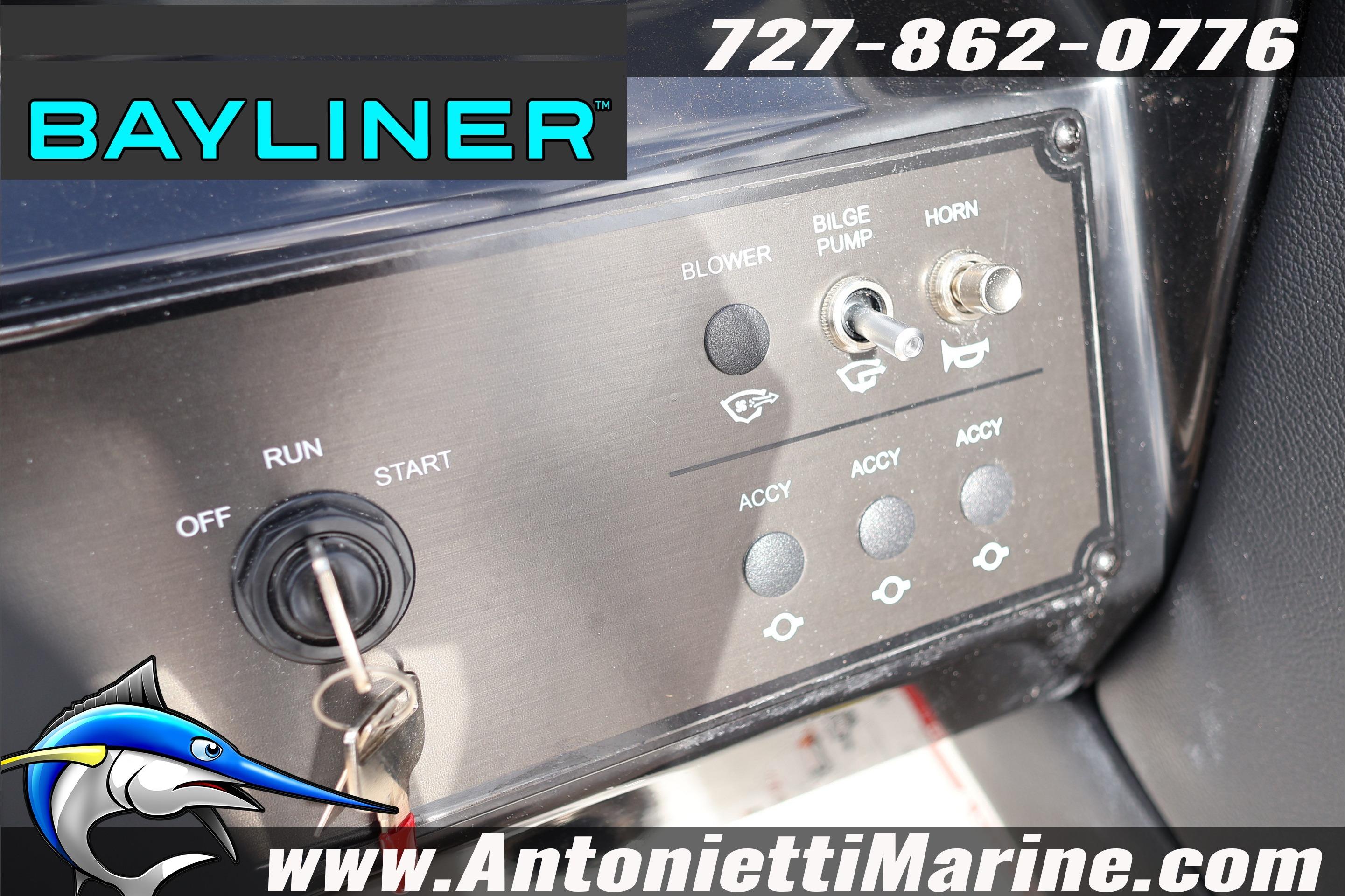 Control panel of a 2026 Bayliner V20 boat with ignition and switches.