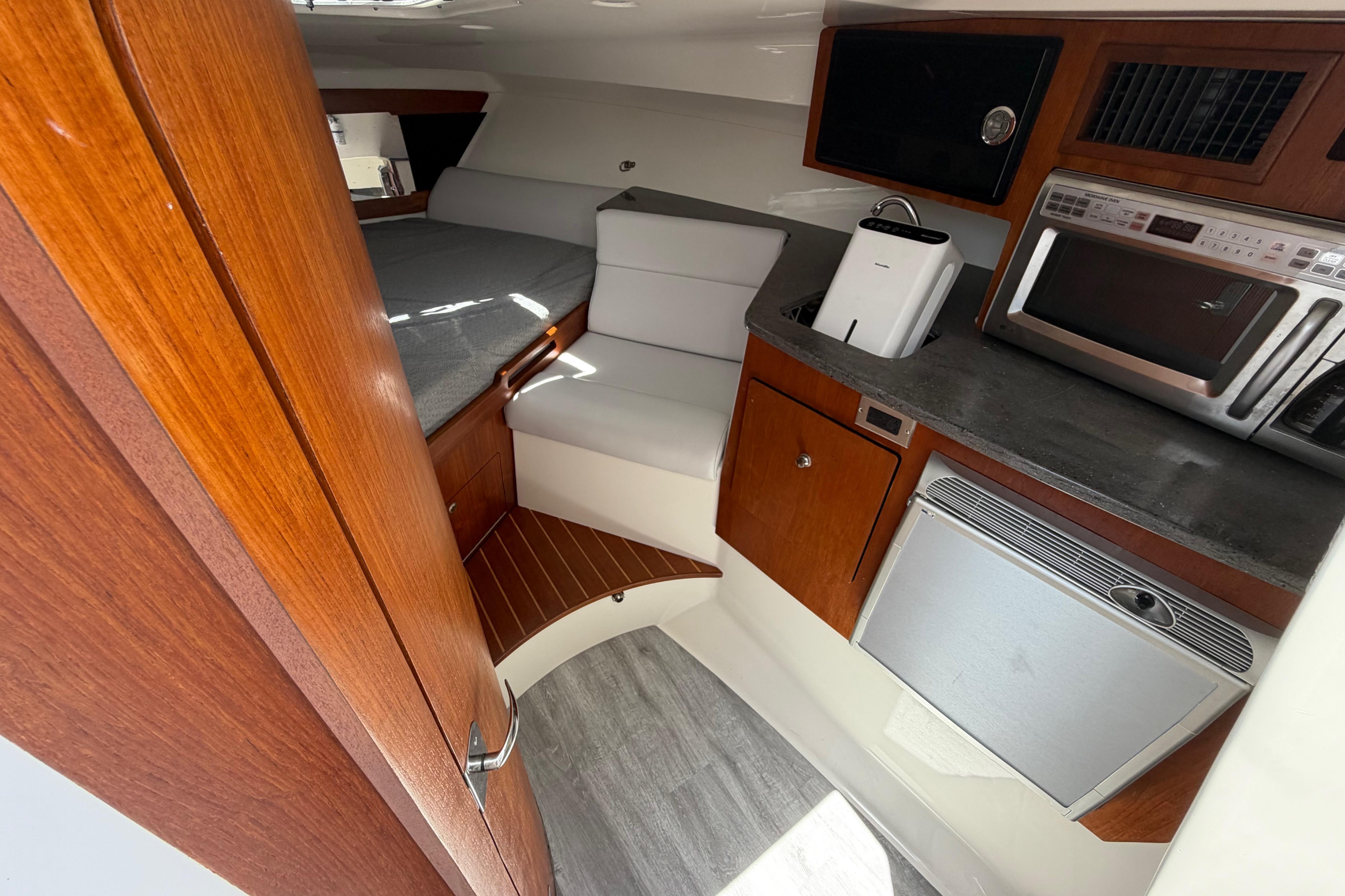 Interior of 2009 Everglades 350LX boat with kitchenette and seating area.