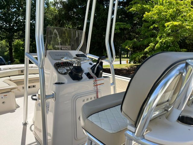 The image shows the cockpit of a Carolina Skiff 21 Ultra Elite boat with helm console and seating.