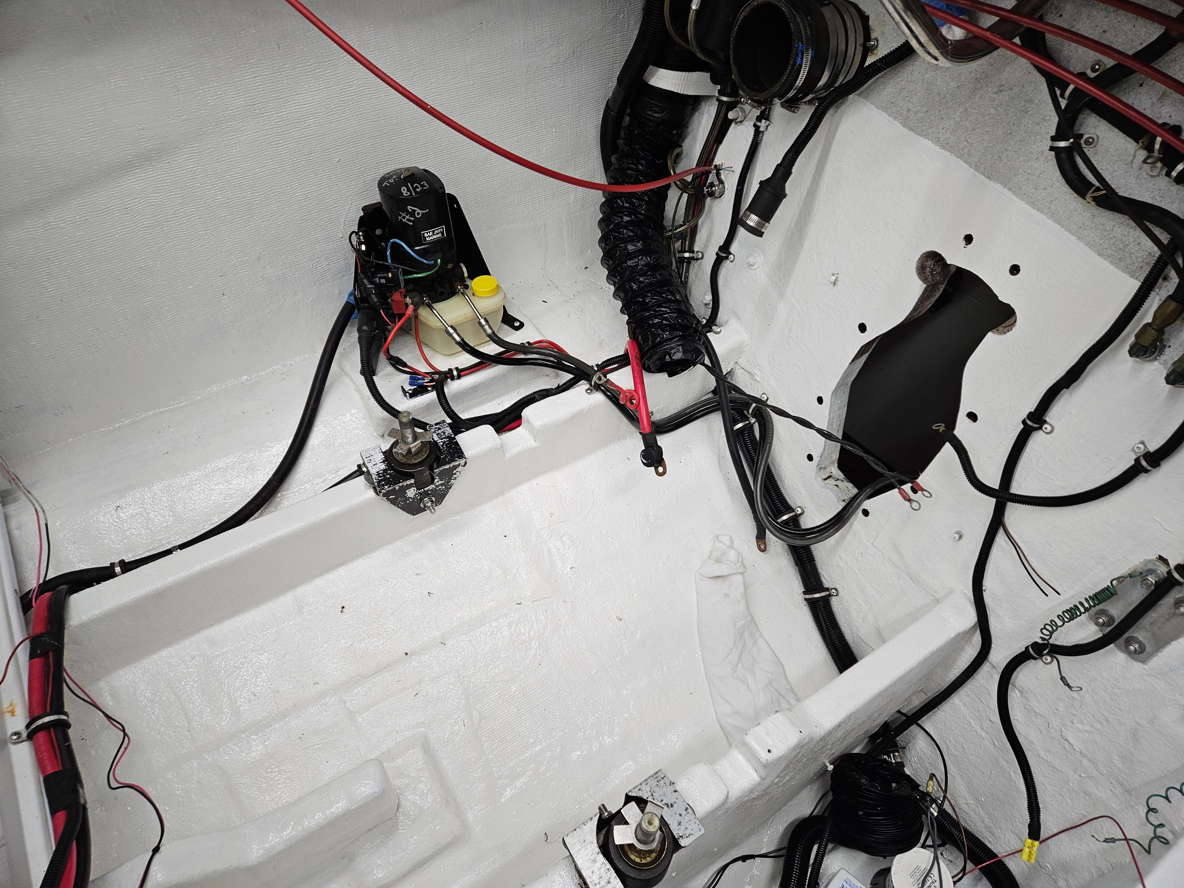 A clean engine compartment with wires and hoses connected to various components.