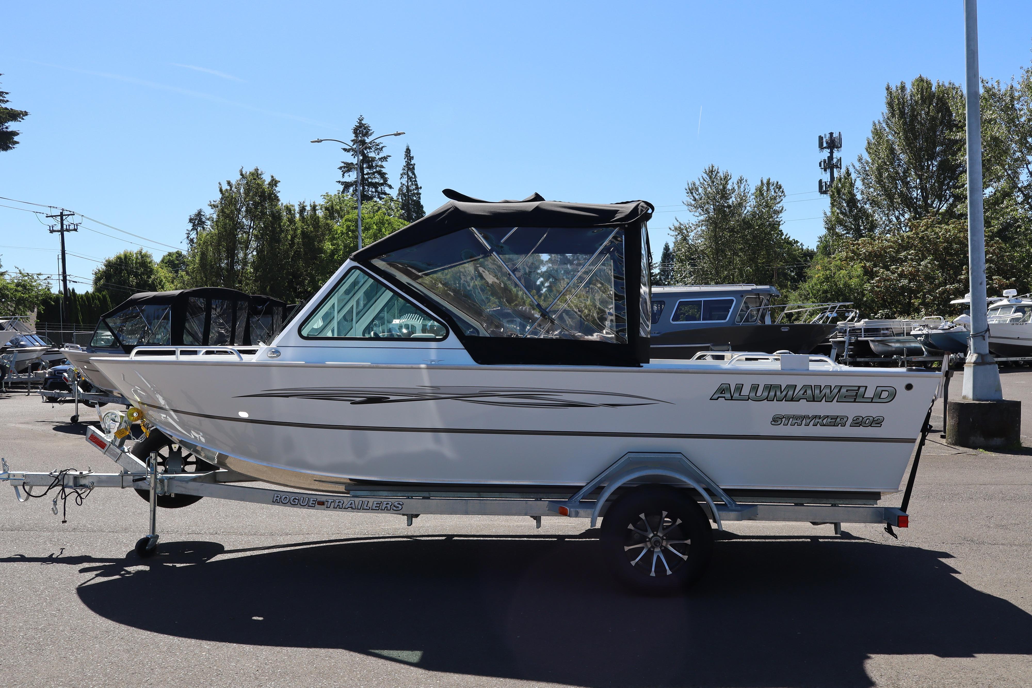2026 Alumaweld Stryker 202 boat on trailer, parked outdoors under clear sky.