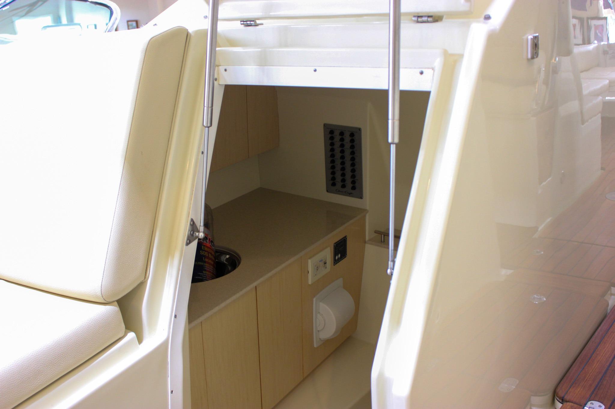 2018 Chris-Craft Calypso 30 interior cabin with seating and storage area.