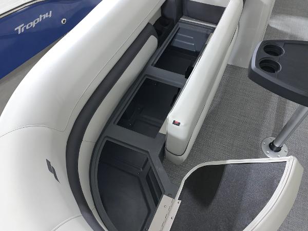 2024 Starcraft EX22 FD boat interior with storage compartments and cup holders.