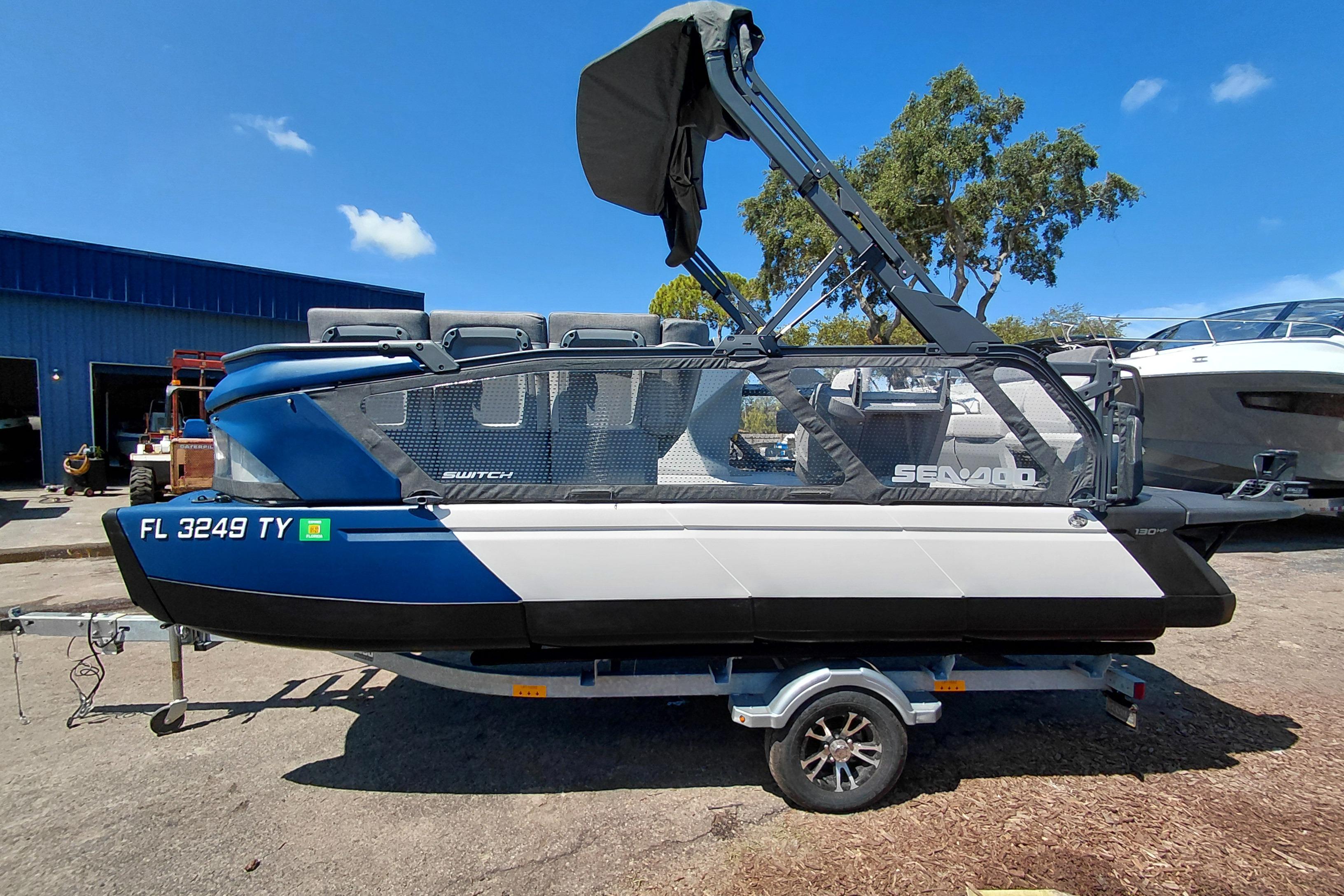 2024 Sea-Doo Switch Cruise 18 pontoon boat on trailer, blue and white design.