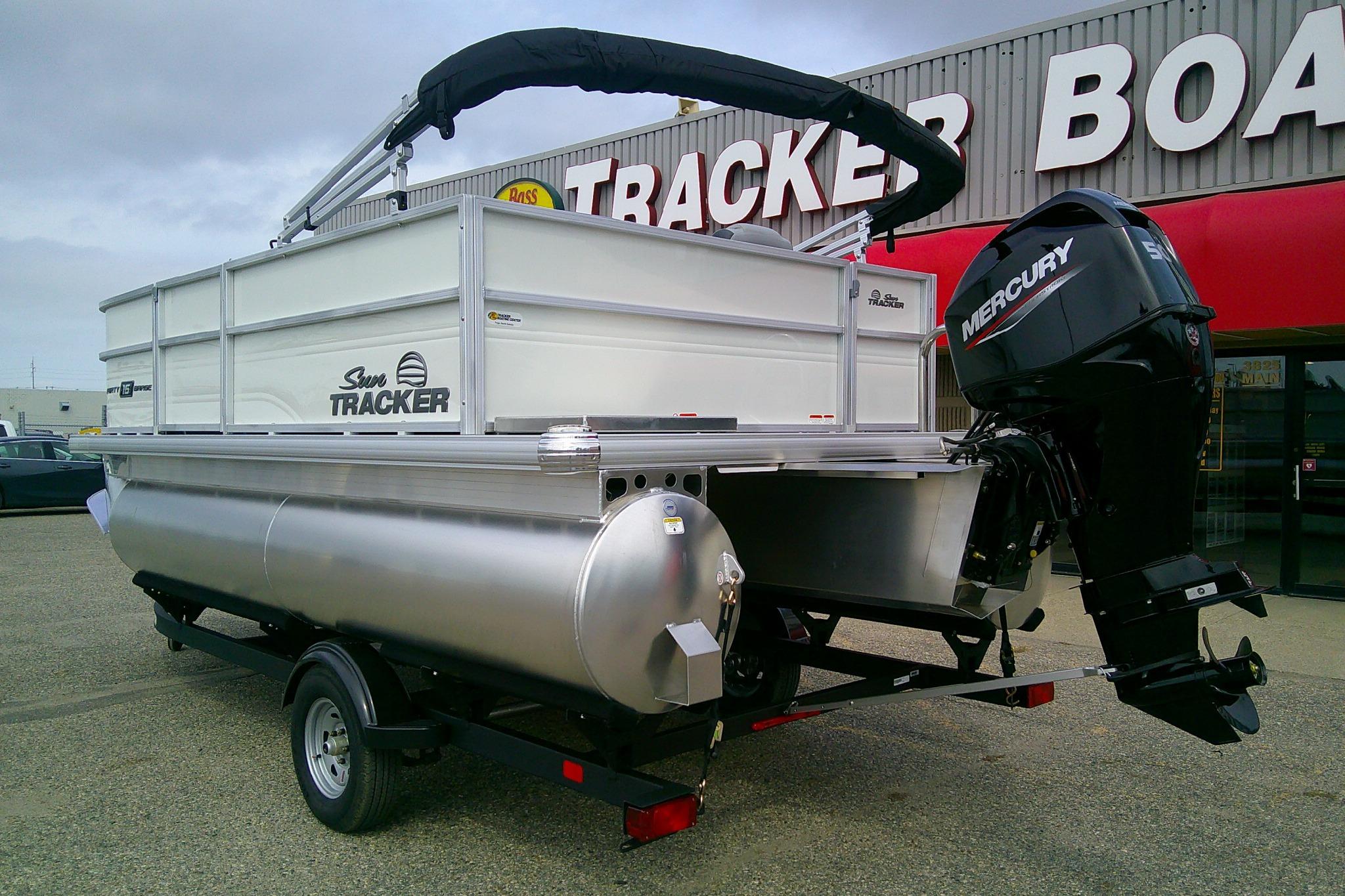 2026 Sun Tracker Party Barge 16 DLX pontoon boat with Mercury engine at dealership.