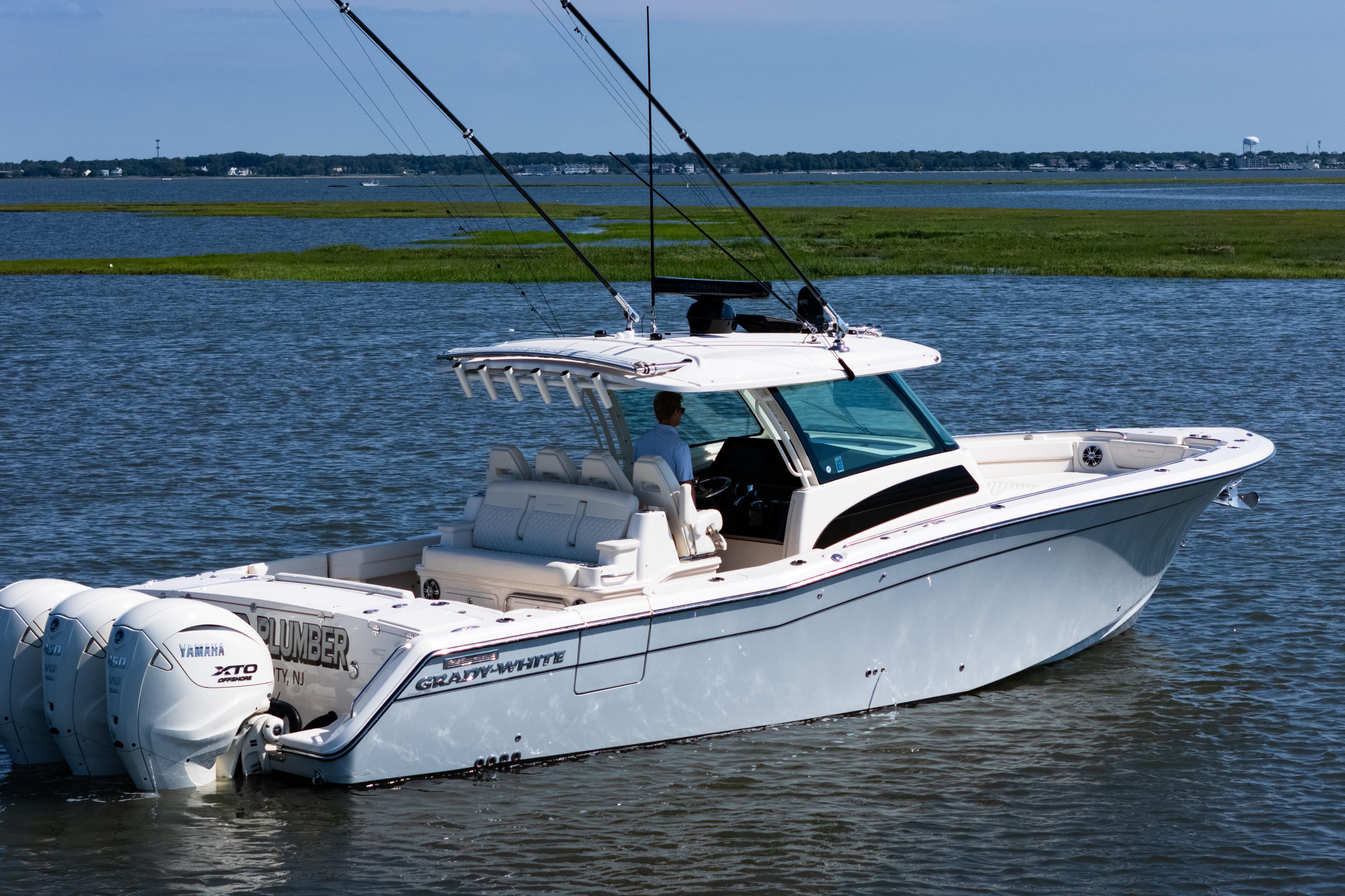 2025 Grady-White Canyon 386 boat on water, featuring triple Yamaha engines.
