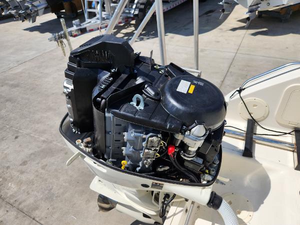 2005 Pursuit 3070 Offshore Center Console engine, detailed view, outdoor setting.