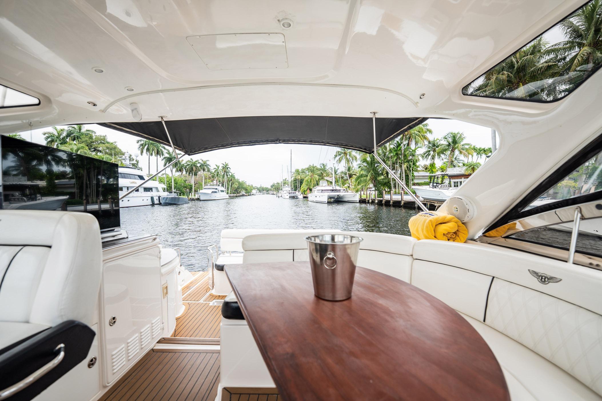 Luxurious 2008 Regal Commodore 4460 yacht interior with waterfront view and elegant seating.