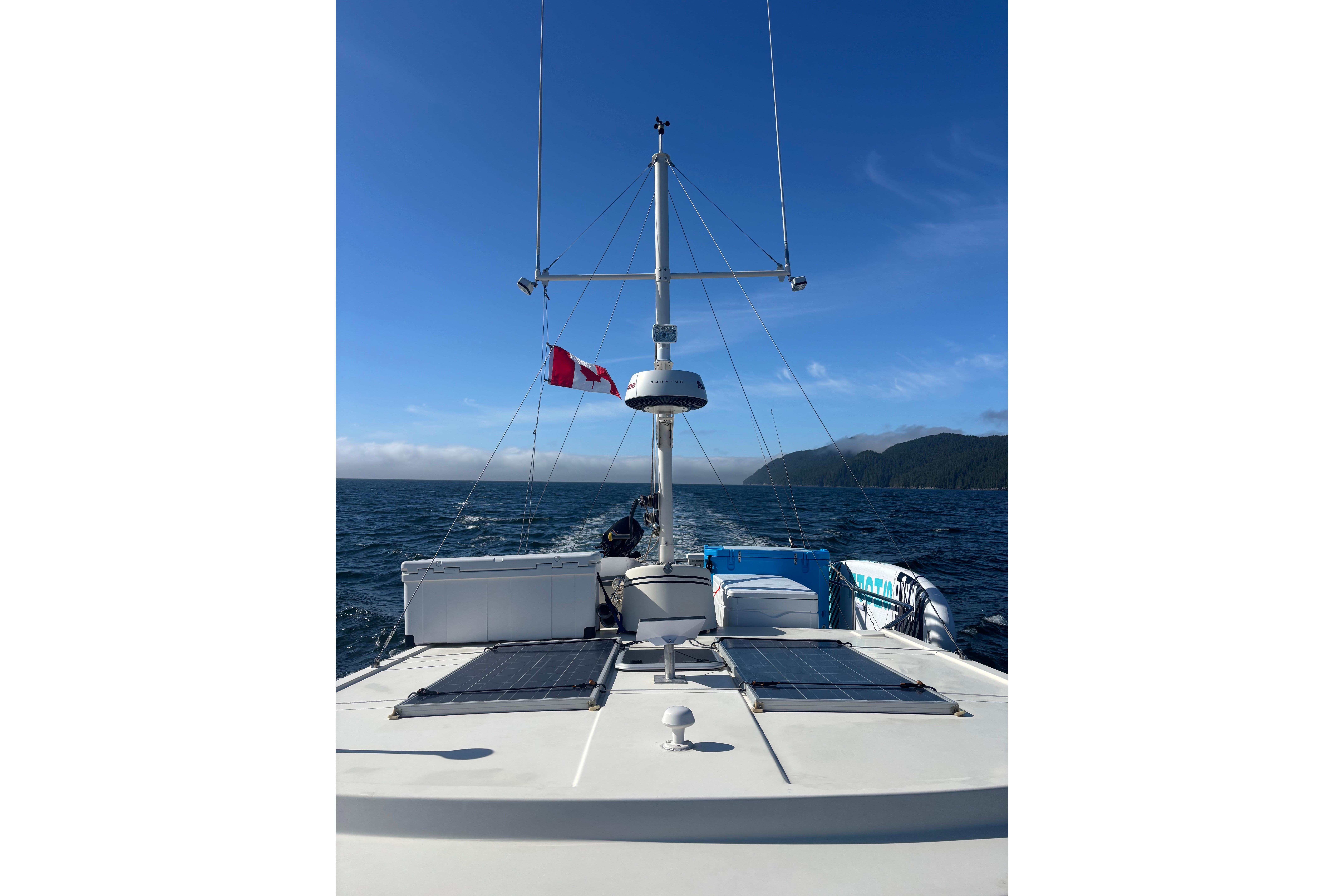 Nordic Tug 37 (2004) cruising on open water with clear blue skies.