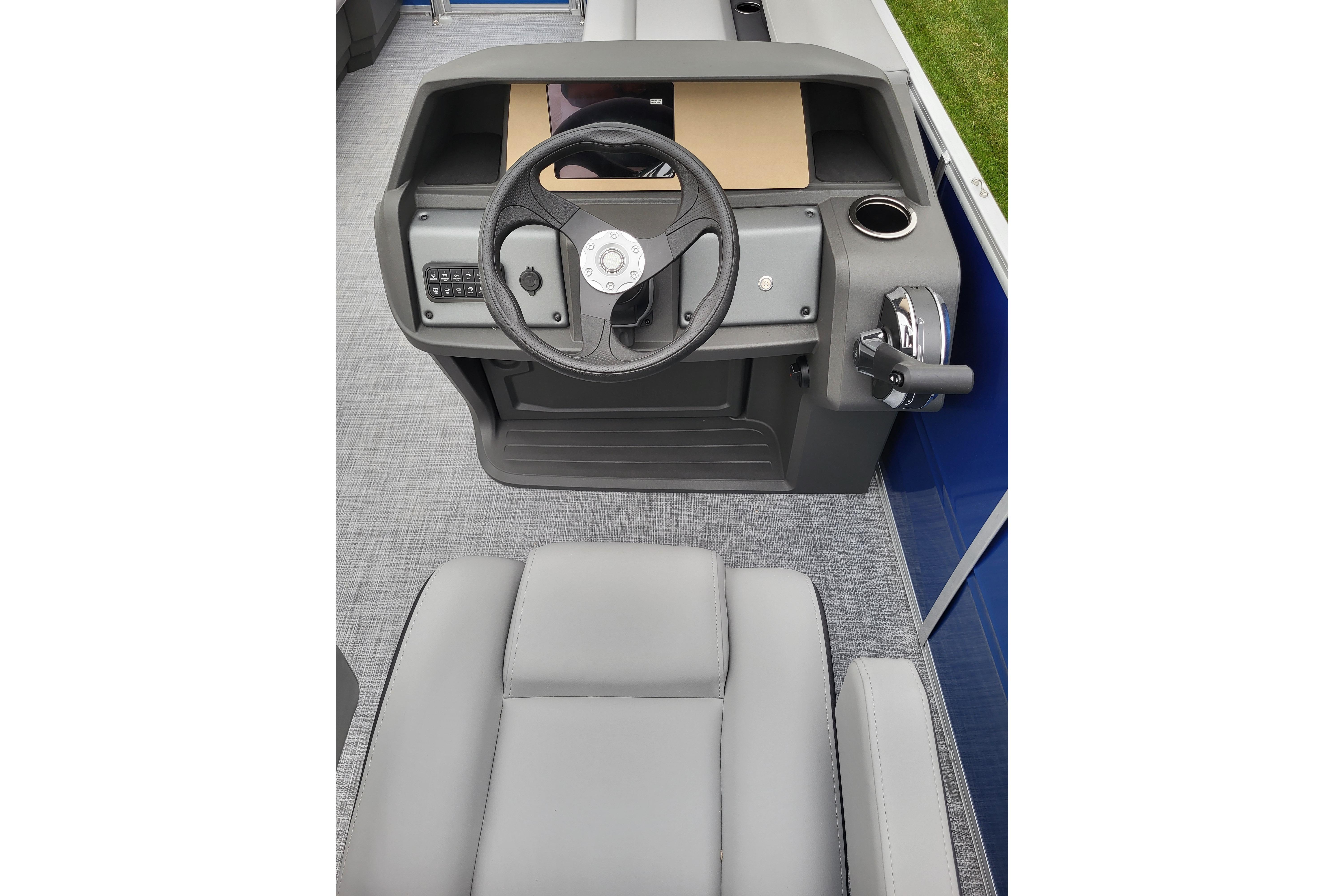 2026 Sun Tracker Party Barge 18 DLX helm with steering wheel and controls.