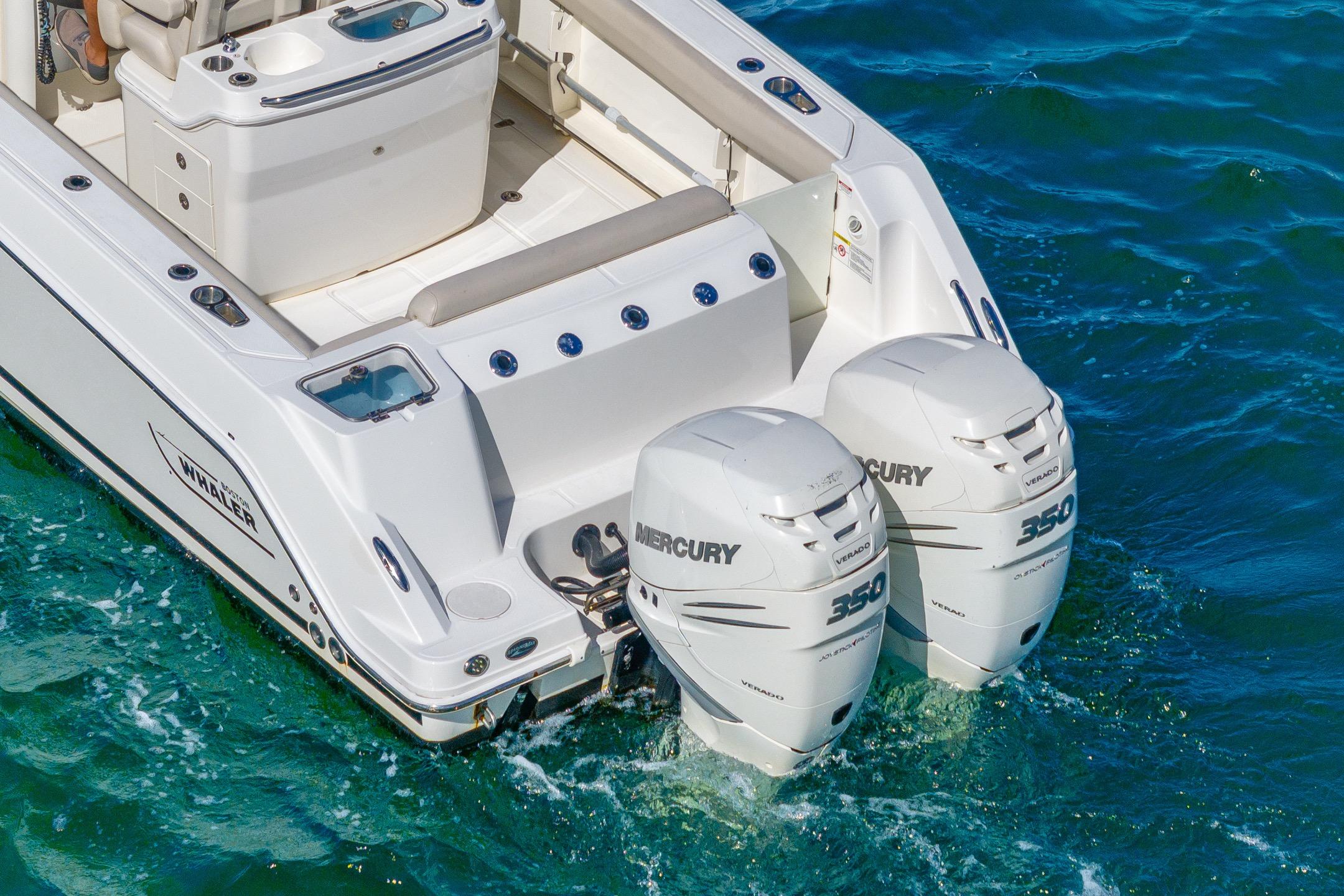 2016 Boston Whaler 280 Outrage with twin Mercury 350 engines on blue water.