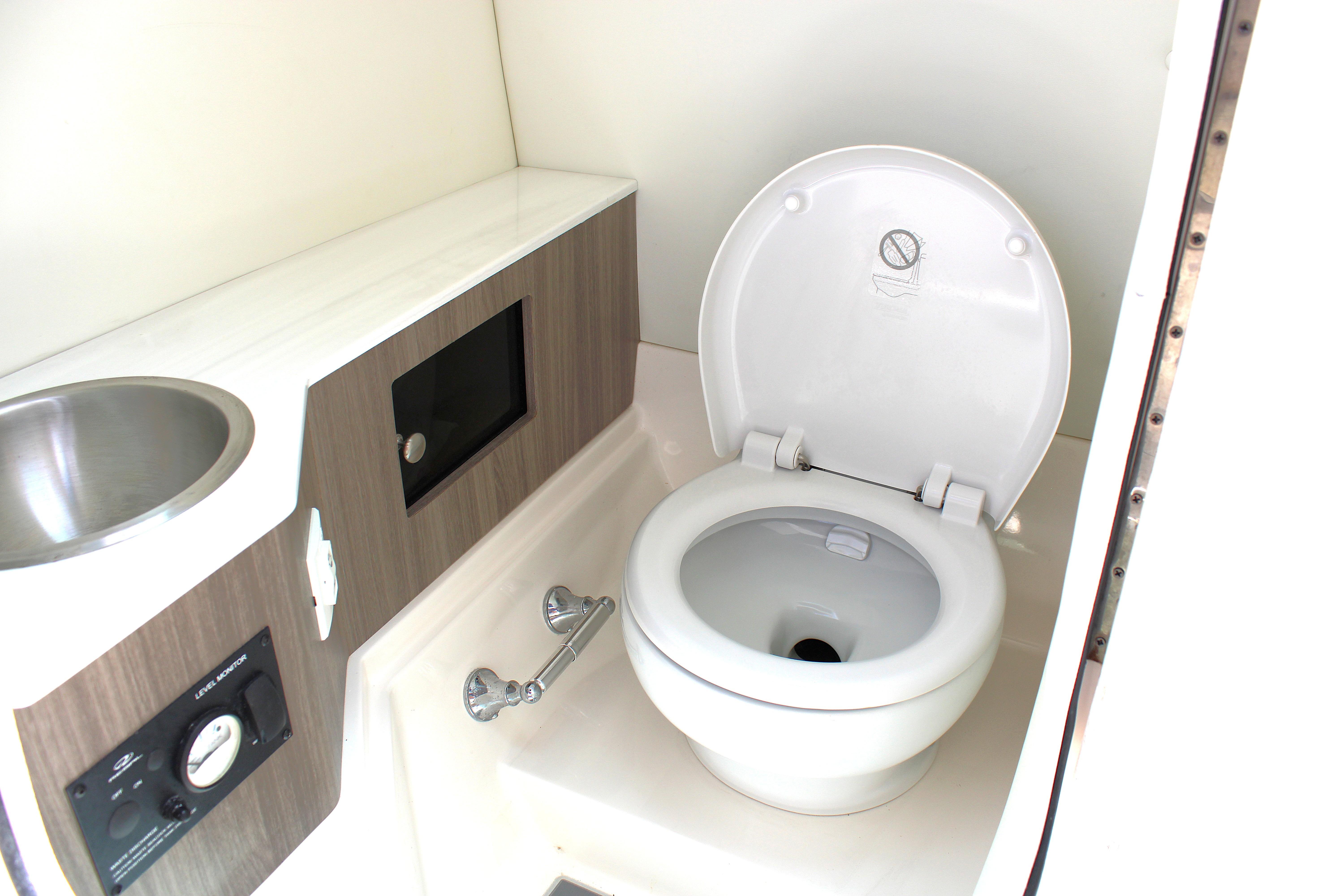 2021 Regal 26 OBX boat bathroom with toilet and sink.