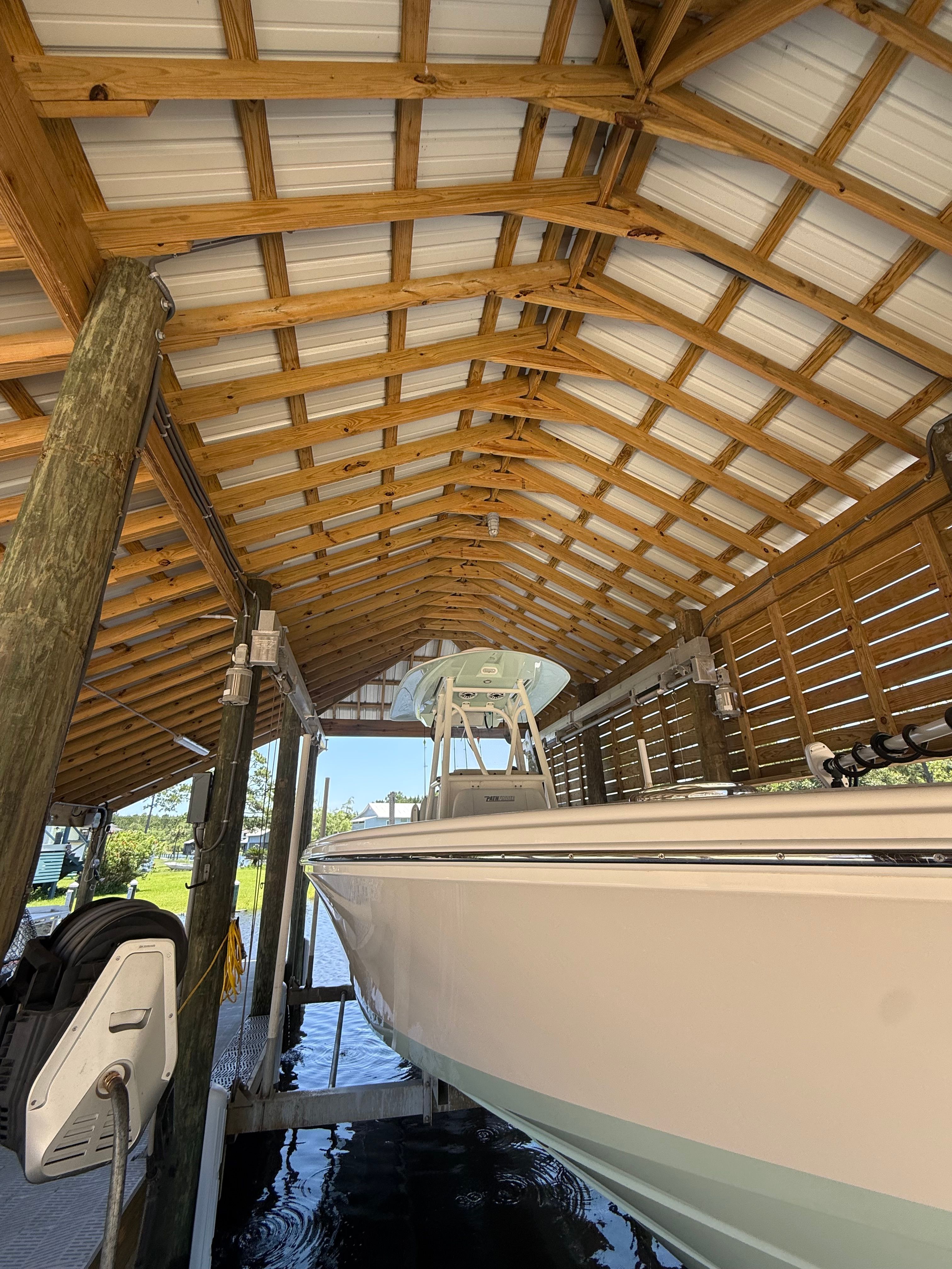 Pathfinder 2700 Open 2024 under a wooden boathouse.