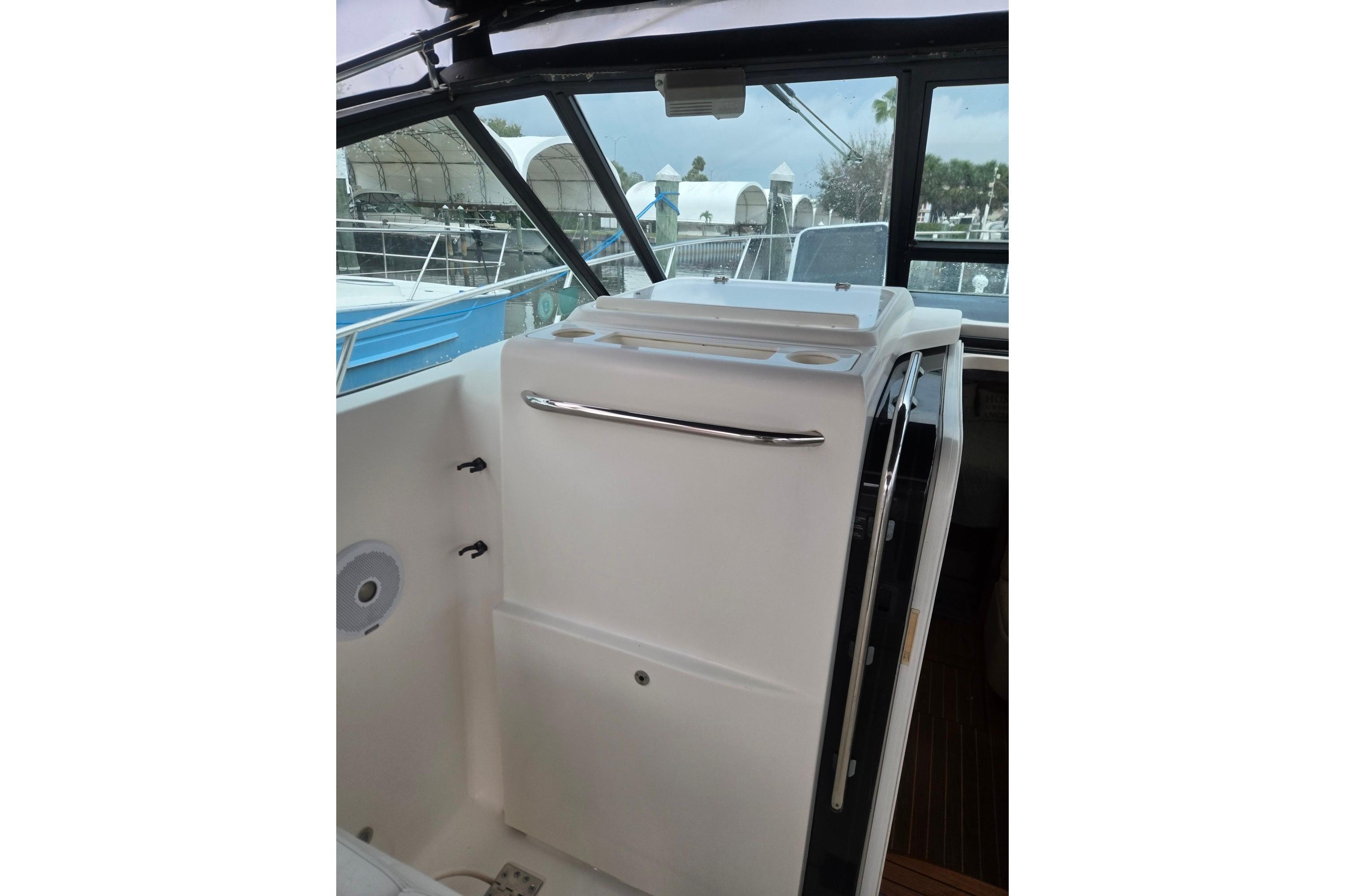 2002 Tiara Yachts 3500 Open cockpit with sleek white interior and stainless steel accents.