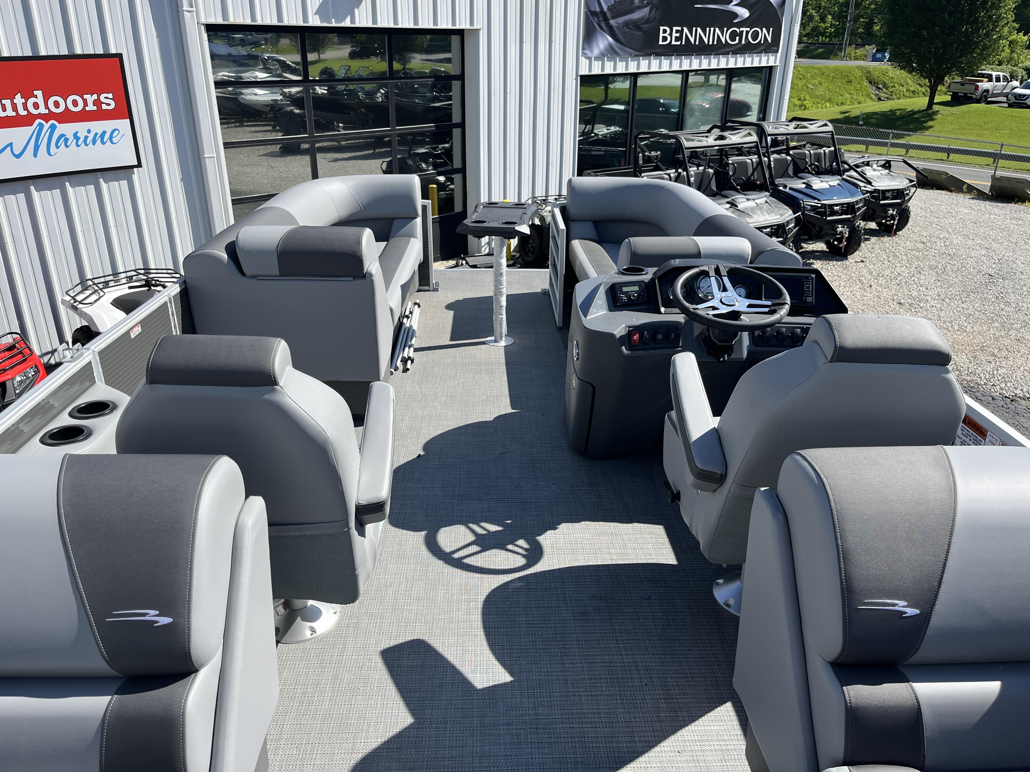 2024 Bennington 22 SVSR pontoon boat interior with gray seating and steering console.
