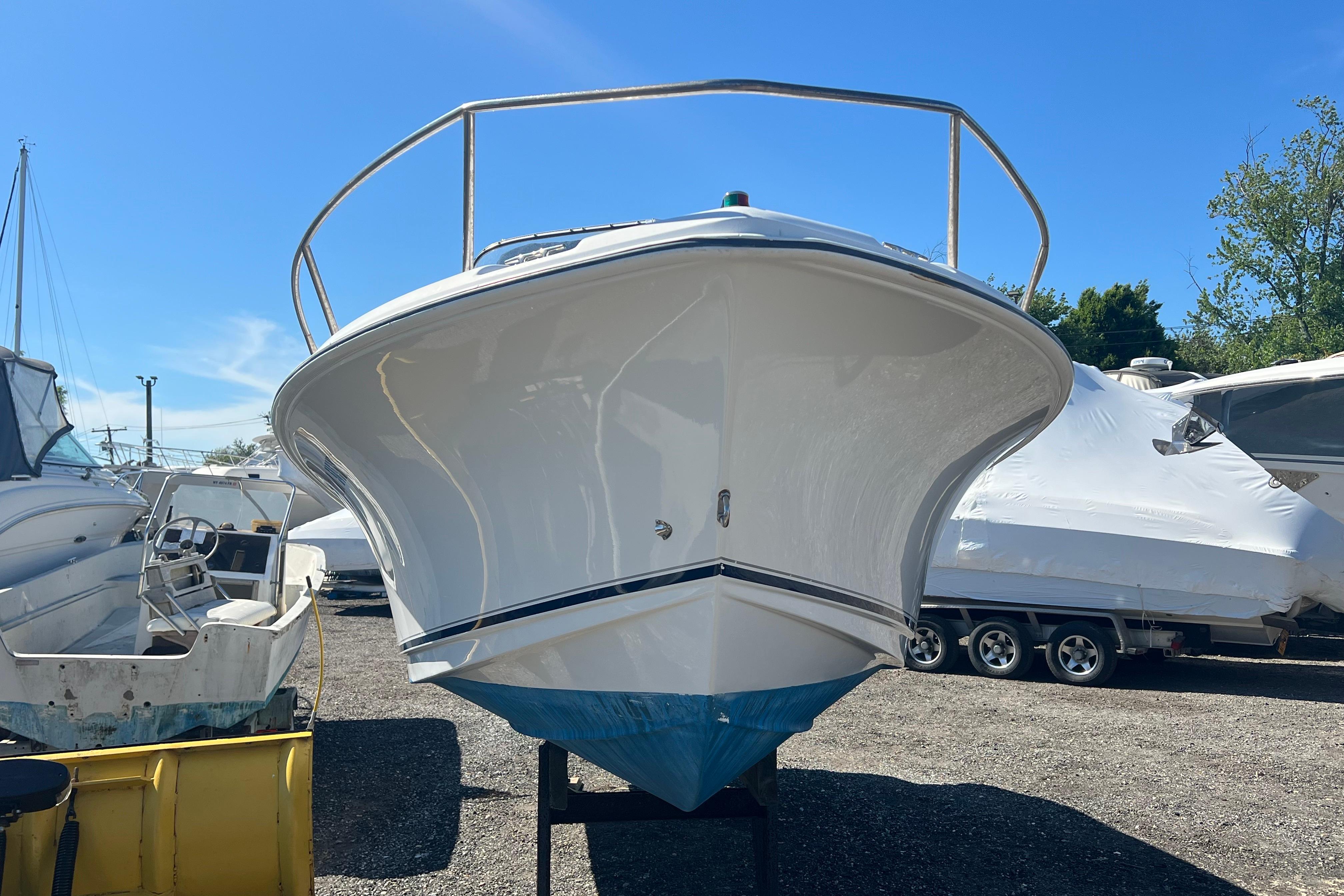 2008 Sea Hunt Victory 207 boat on display in a marina under clear blue skies.