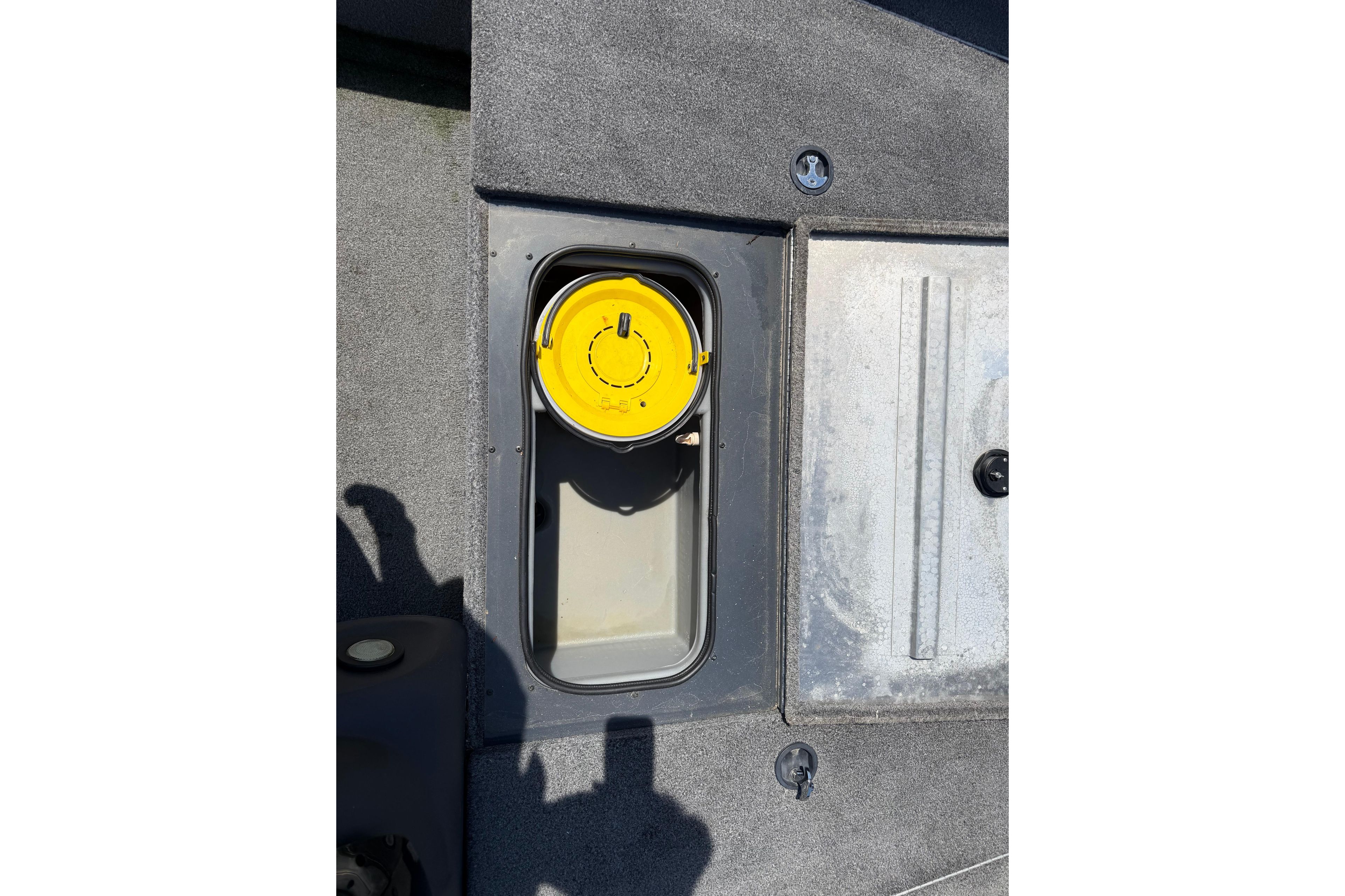 2019 Tracker Pro Team 175 TF boat compartment with yellow lid, gray interior.