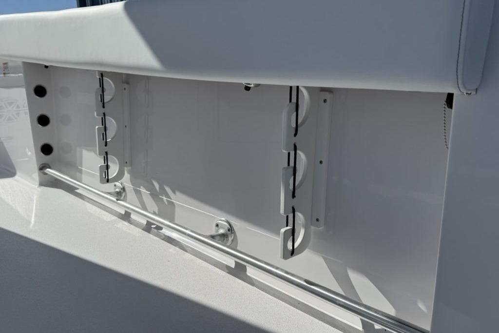 2026 Sportsman Open 232 Center Console boat interior detail with rod holders.
