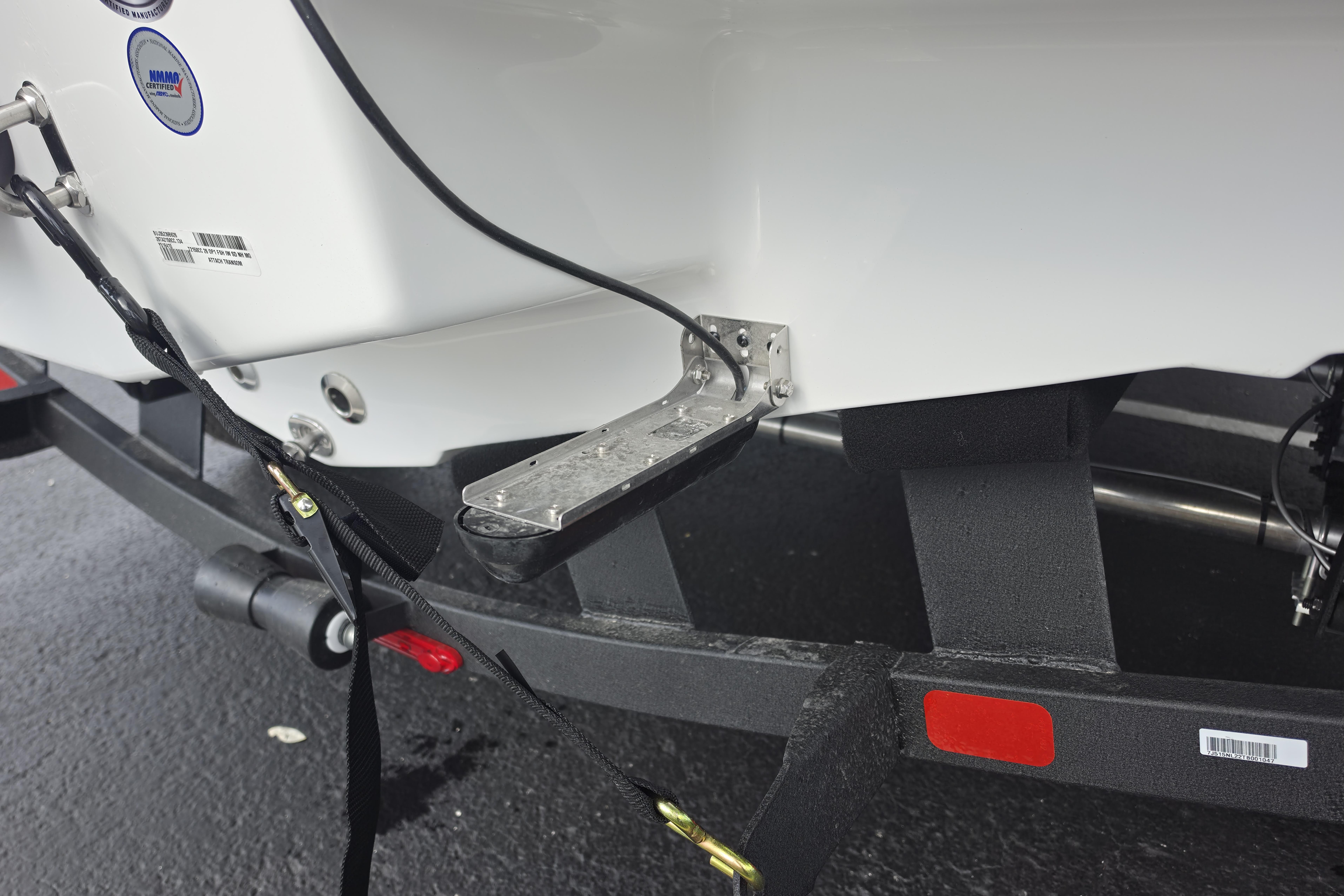 2026 Tahoe 2150 CC boat on trailer, showing rear step and securing straps.