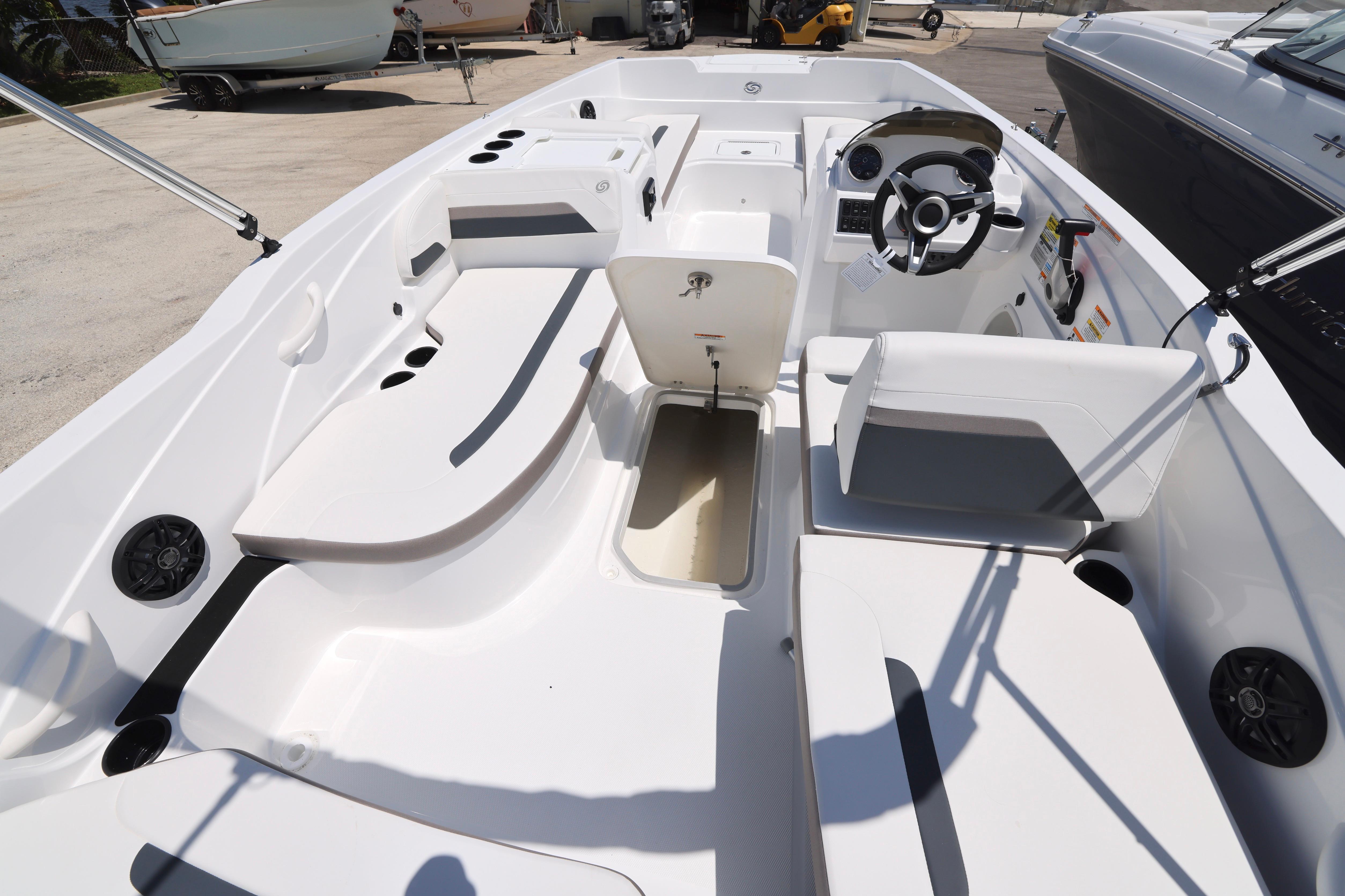 2026 Hurricane SunDeck Sport 205 OB boat interior with seating and steering wheel.