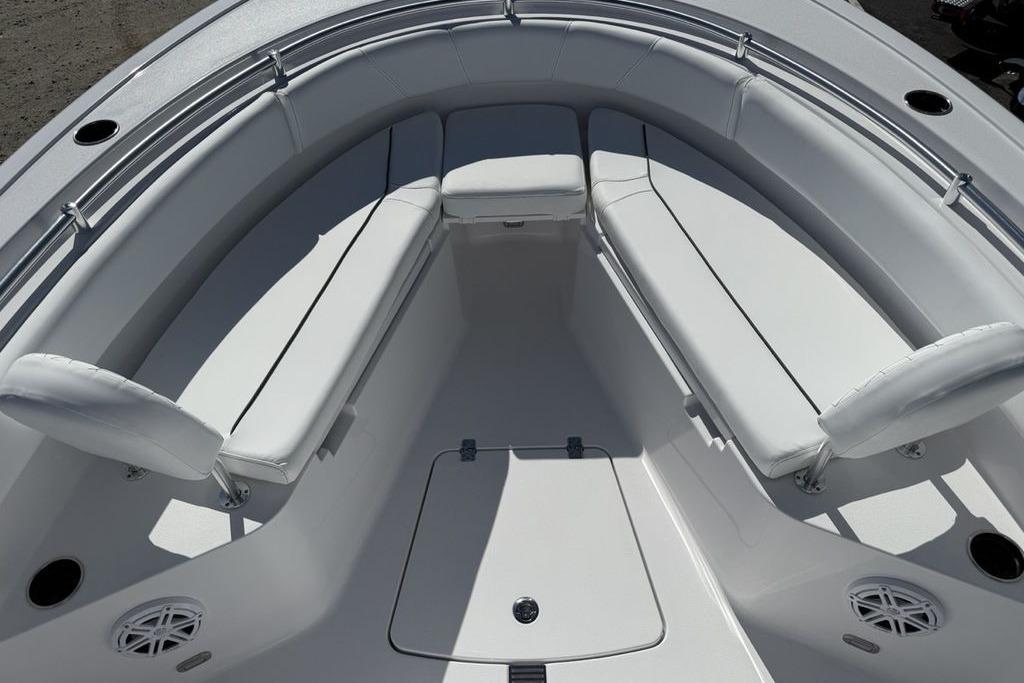 2026 Sportsman Open 232 Center Console boat interior with white cushioned seating.