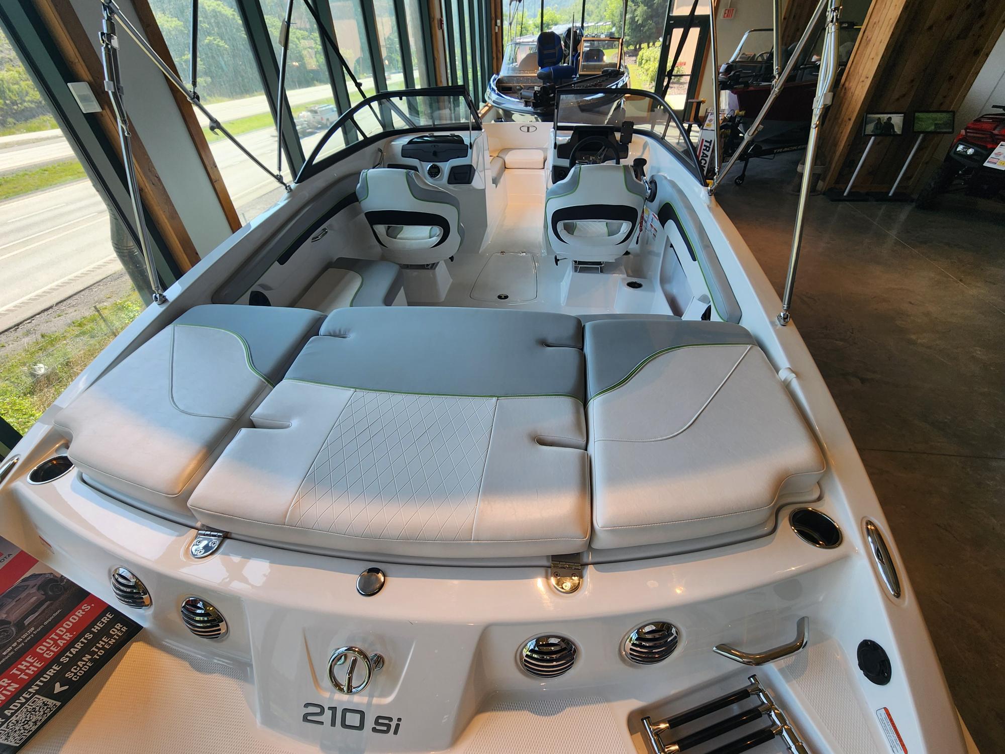 2024 Tahoe 210 Si boat interior with sleek seating and modern design in showroom.