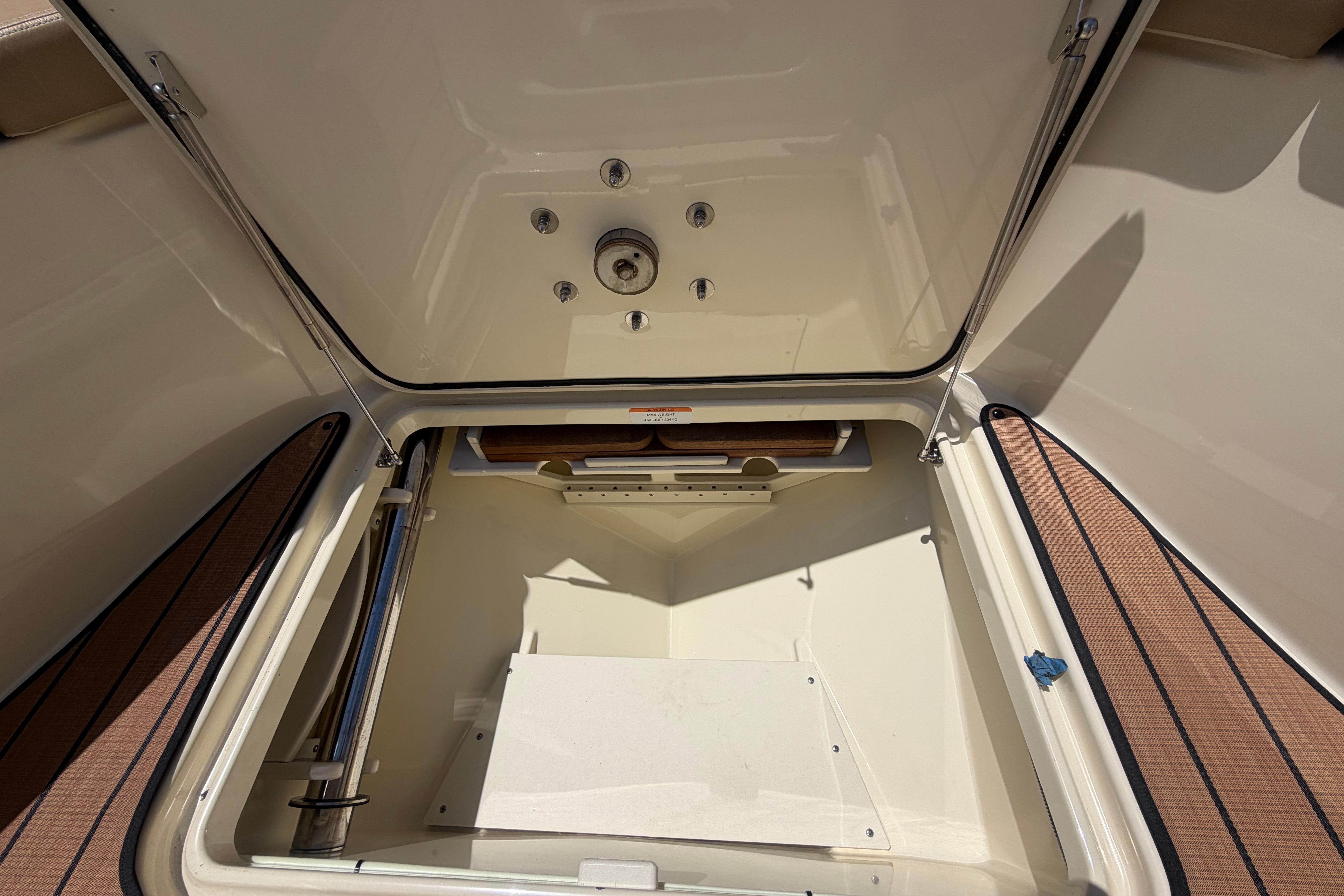 Open storage compartment on a 2017 Chris-Craft Catalina 34 boat.