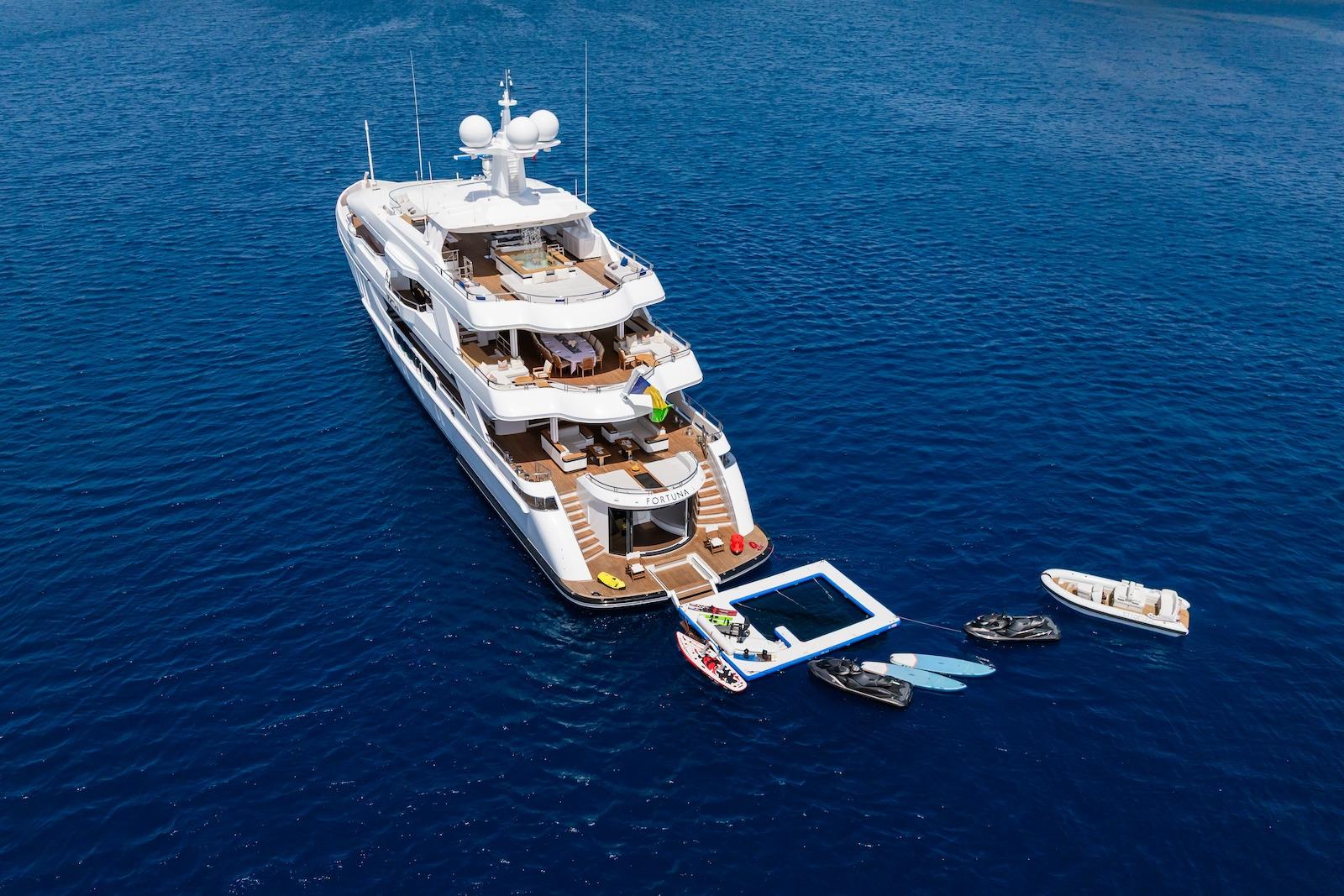 Luxurious 2022 CMB Yachts CMB 47 on serene blue ocean with water toys.