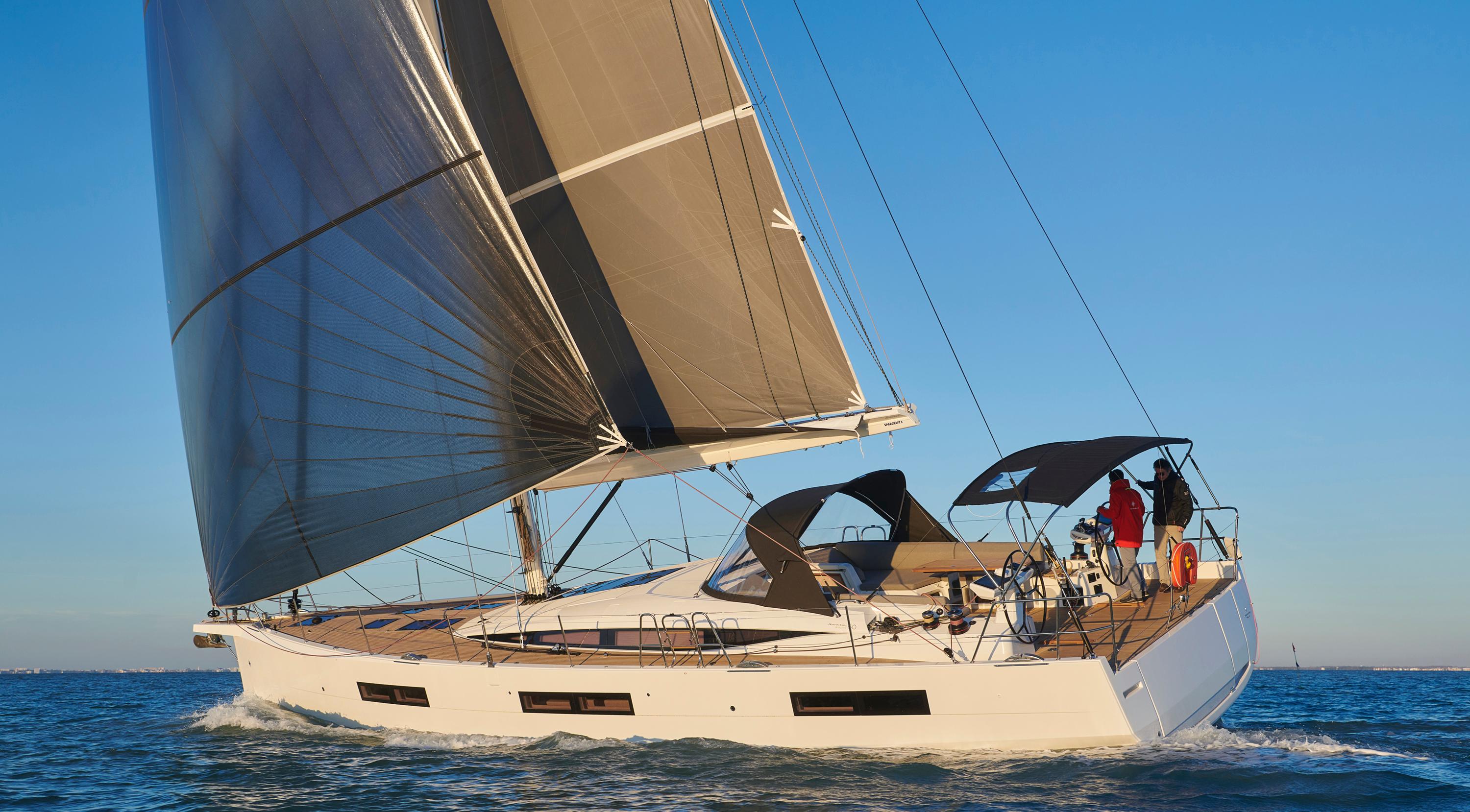 2026 Jeanneau Yachts 60 sailing on open water under clear blue skies.
