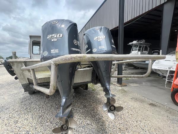 Custom Flat 28 Cabin Boat 2010 with dual 250 V6 engines in a boatyard.
