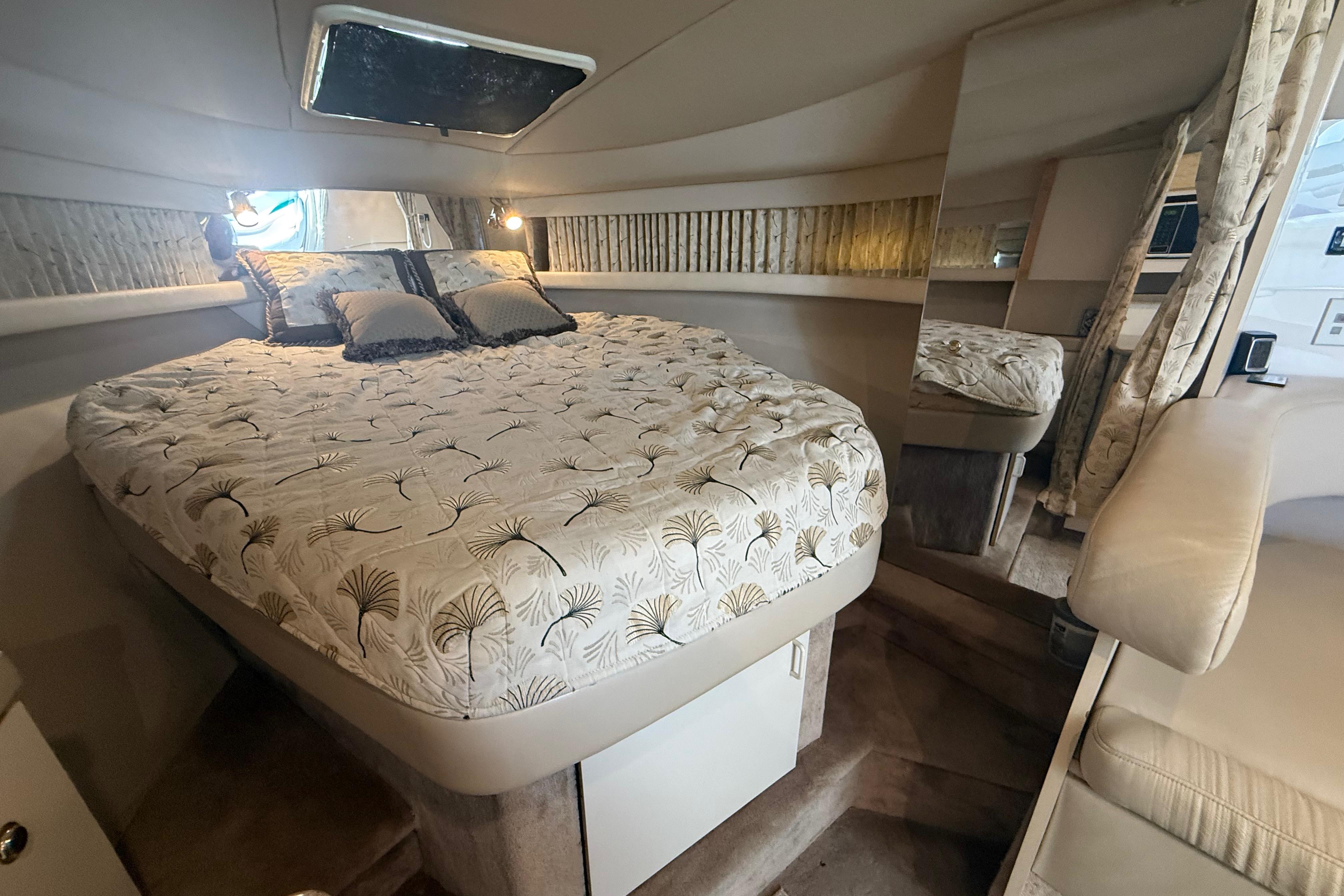 1999 Formula 34 Performance Cruiser cabin with cozy bed and elegant decor.