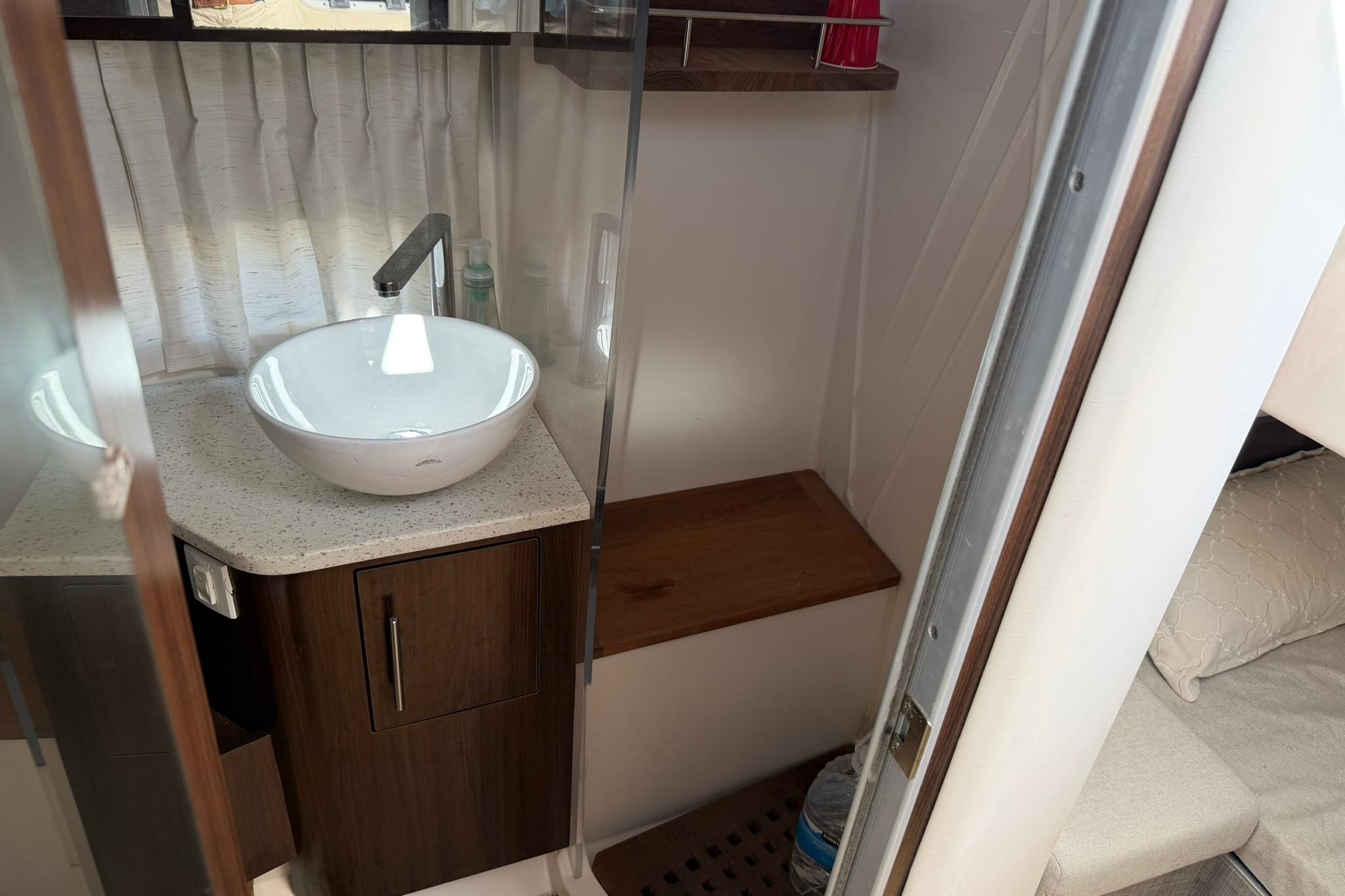 2019 Regal 33 SAV boat interior with modern sink and wooden cabinetry.